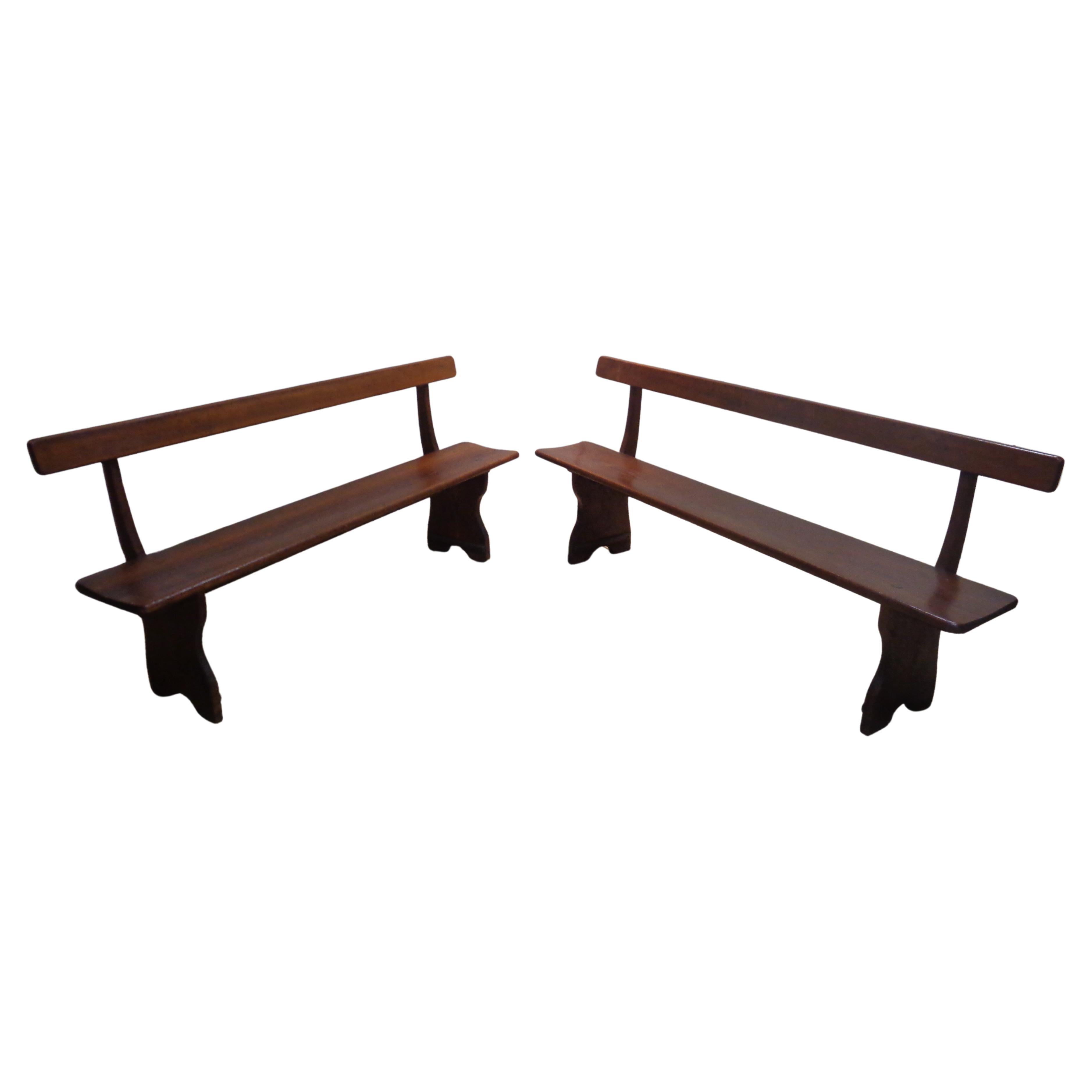 Exceptional pair of antique American country stained yellow pine hardwood benches w/ fine hand crafted dowel pegged construction / nicely grained / beautifully aged original rich color patina / graceful elongated sculptural form. One bench is 72