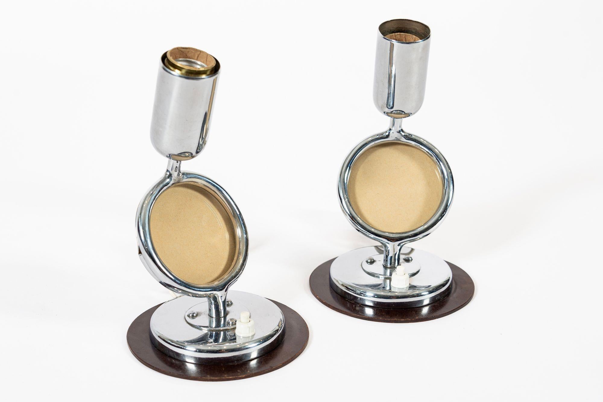 Este raro par de lámparas de mesa antiguas de estilo Art Déco Bauhaus datan de 1930. Estas preciosas y pequeñas lámparas de sobremesa de cromo pulido presentan un diseño sencillo y modernista de líneas limpias y curvas suaves, e incorporan secciones