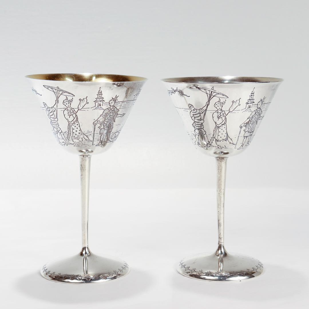 A fine pair of Art Deco martini or cocktail glasses

In sterling silver.

By the Gorham Manufacturing Co.

Each with engraved feet supporting slender pedestals and tapered cups with deeply engraved with stylized Japanese landscape scenes to their