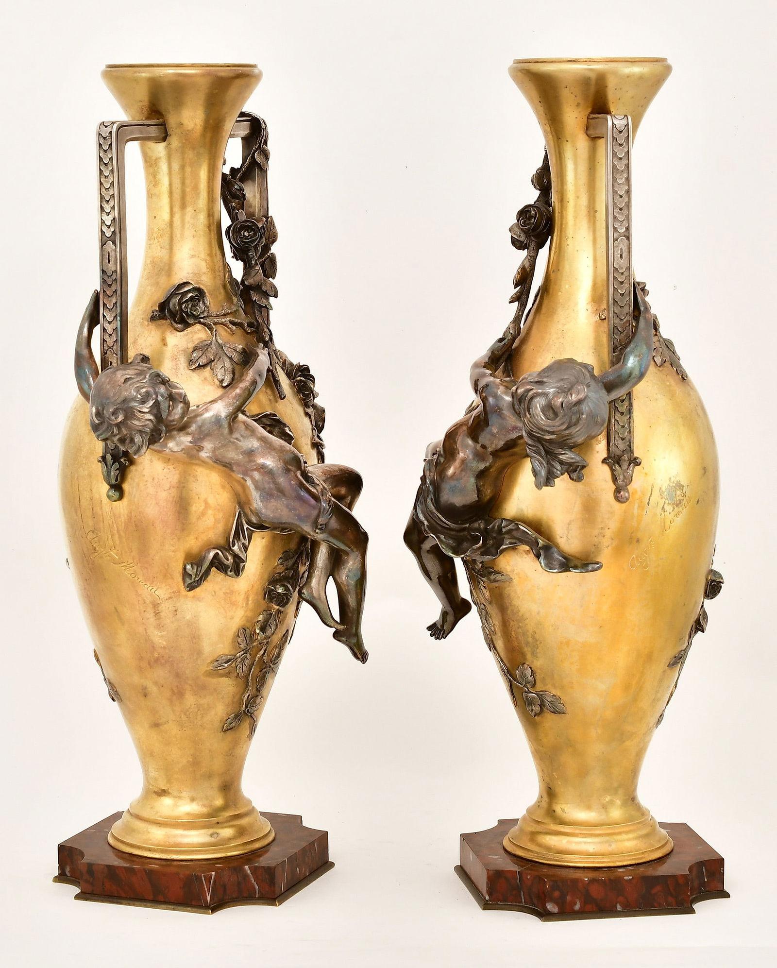 Pair of Finest quality casting  antique Art Nouveau period gilt bronze vases by Auguste Moreau (French, 1934-1917) with finely cast figures of cherubs with silvered patinas, and rouge marble bases.  Each 20.5 by 10 by 7 inches.  Each signed Augt.