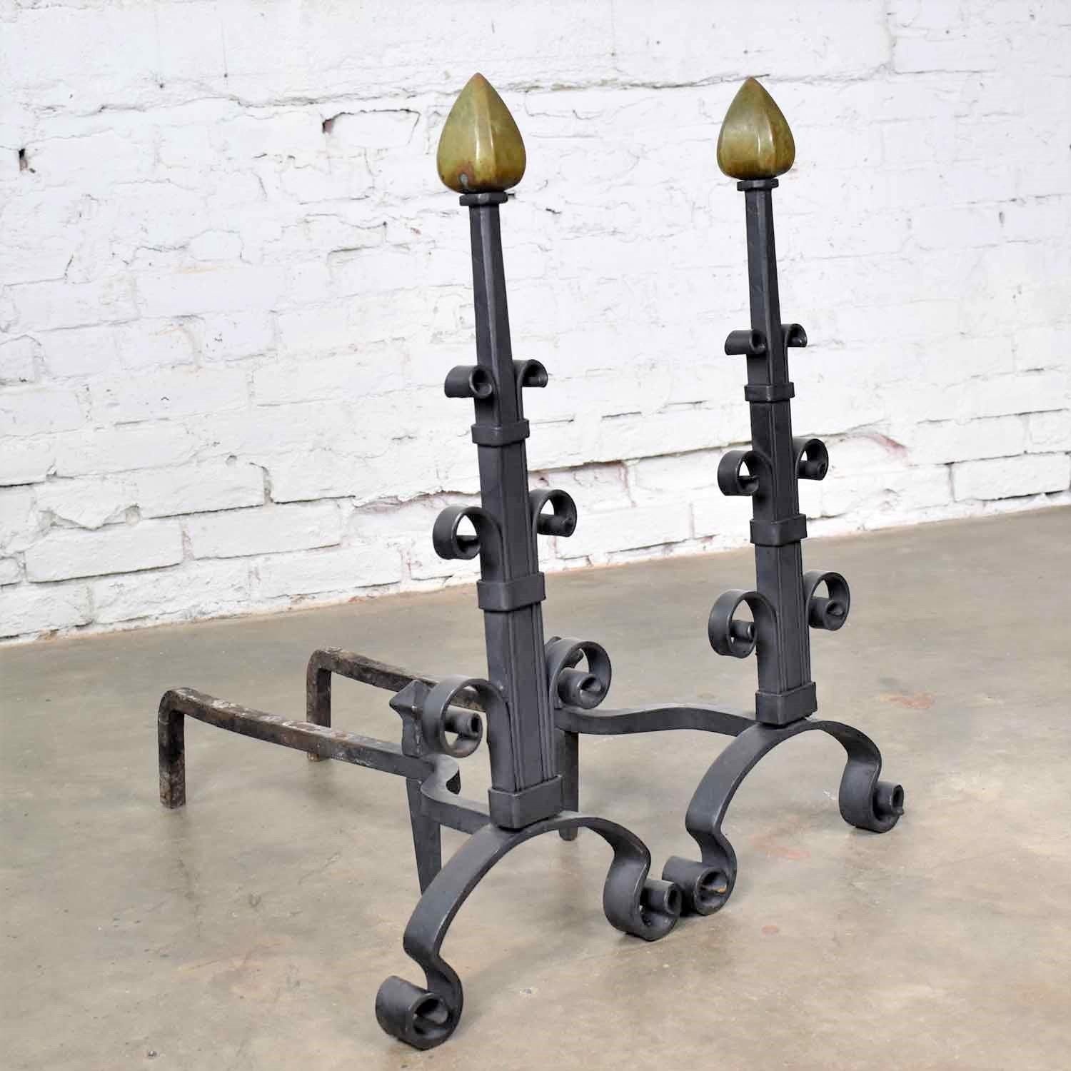 Handsome pair of antique Arts & Crafts or Art Deco hand wrought iron and bronze andirons. They are in wonderful antique condition with a very lovely age patina. All we have done is clean them. In our opinion they are ready to use, circa early 20th