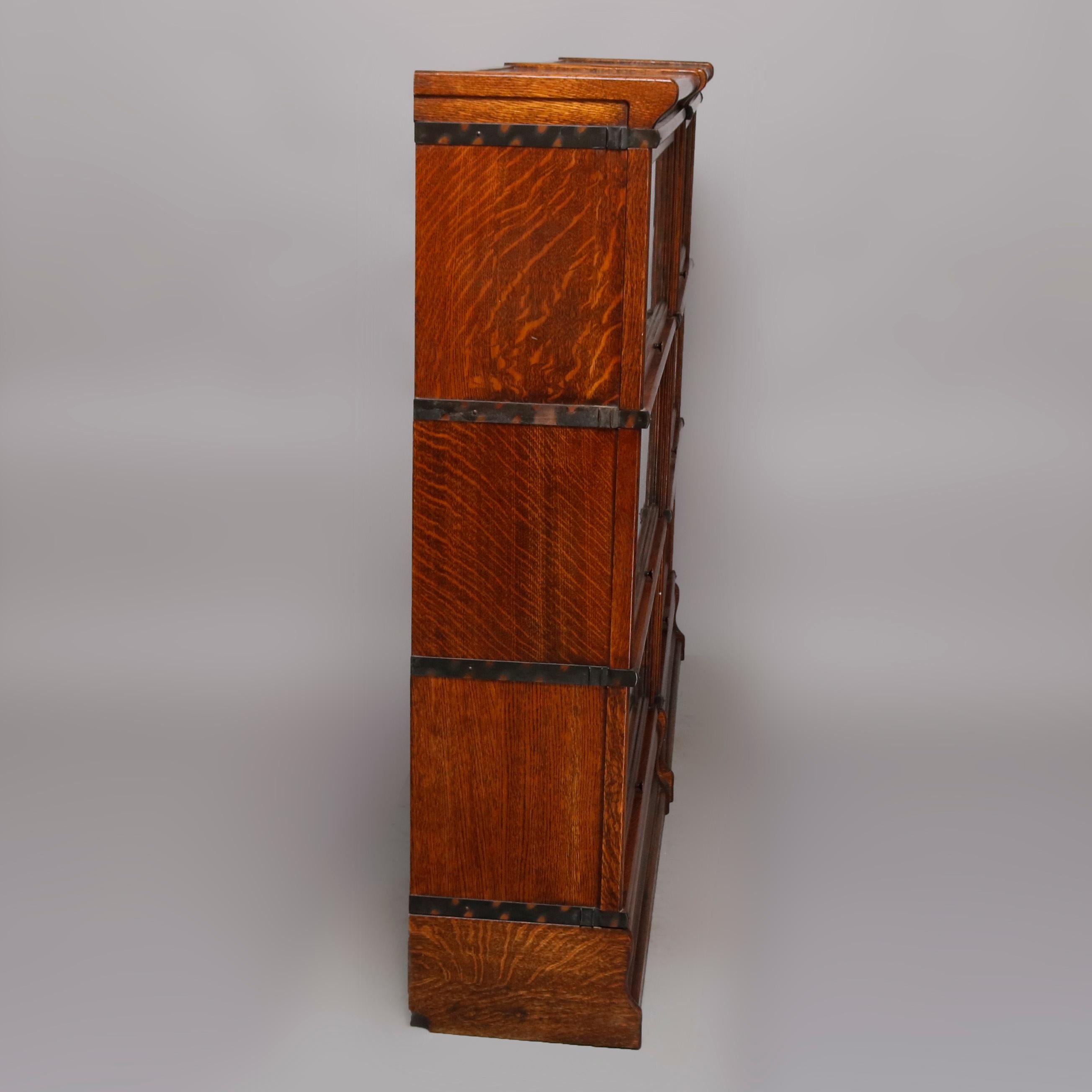 A pair of antique Arts & Crafts barrister bookcases by Macey each offer oak construction with Finish 2 and having three sections with glass doors, crown and base, original label as photographed, circa 1920

Measures: 49