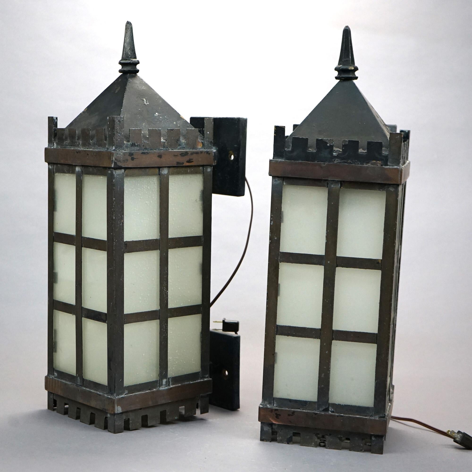 An antique pair of Arts & Crafts exterior wall sconces offer wrought metal frames with Gothic style top over paned sides, circa 1920

Measures - 24.75