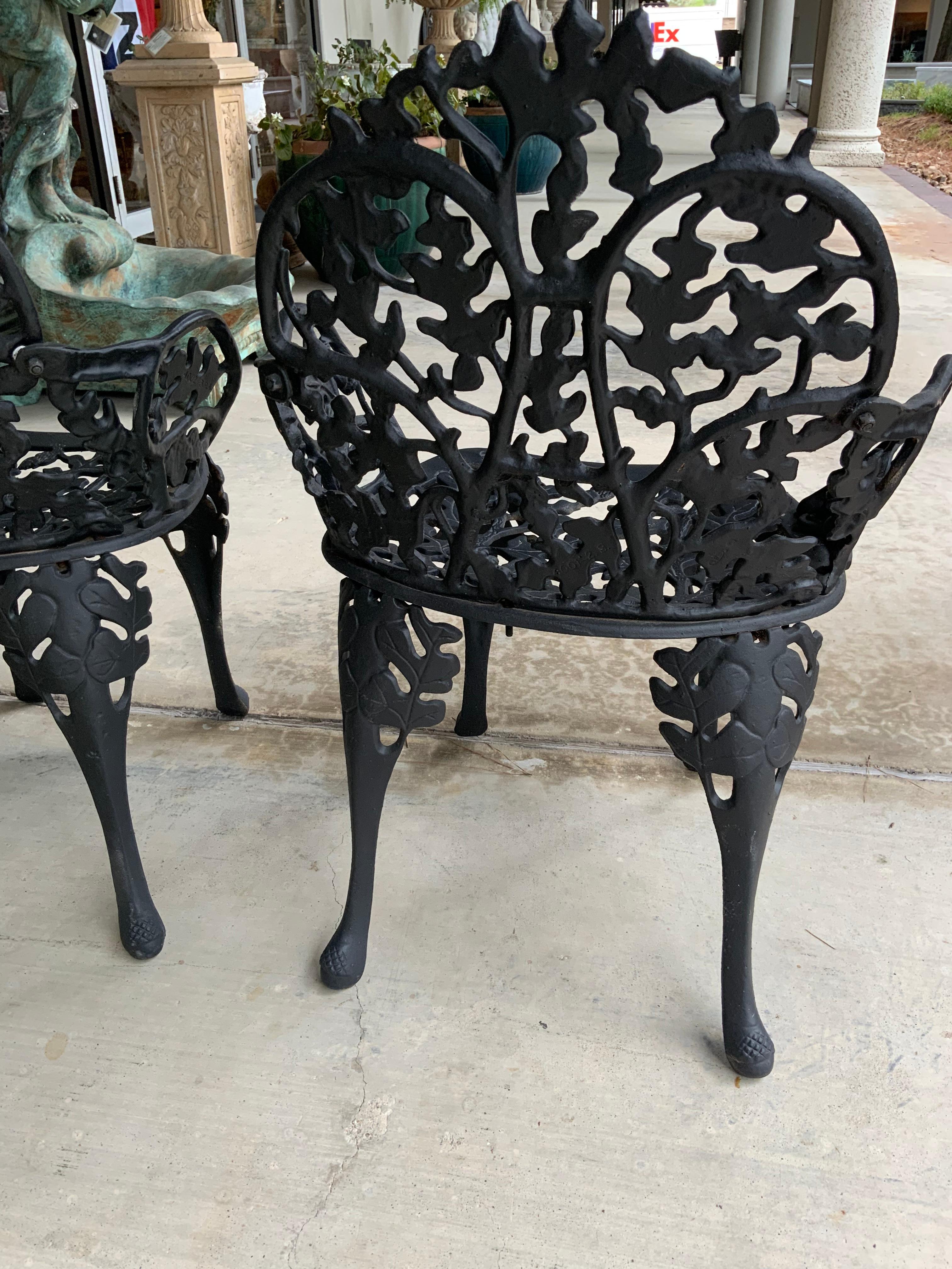 American Pair Antique Black Iron Garden Chairs with Faux Bois Design Acorn and Foliate For Sale