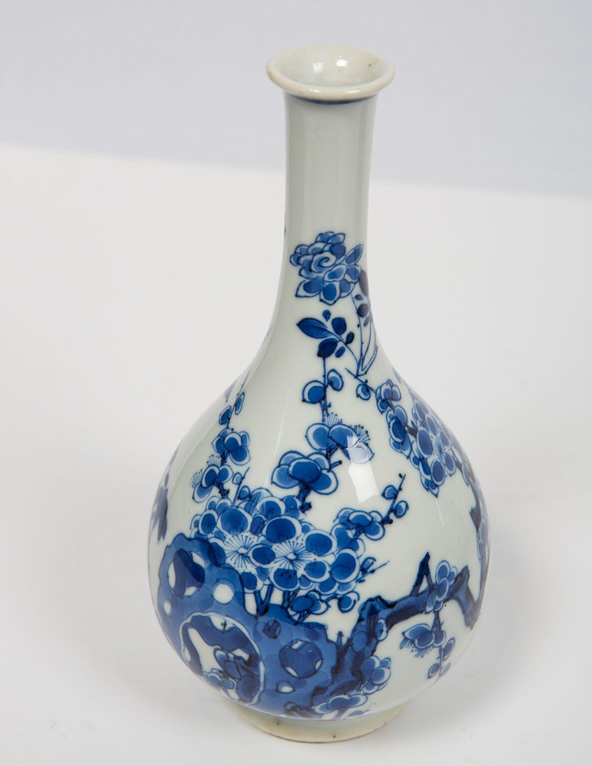 WHY WE LOVE IT: The finest we've ever had.
We are excited to offer this outstanding pair of Kangxi era blue and white vases. They are elegantly painted with lovely naturalistic scenes.  The smooth surface of each oil-drop shaped bottle is adorned