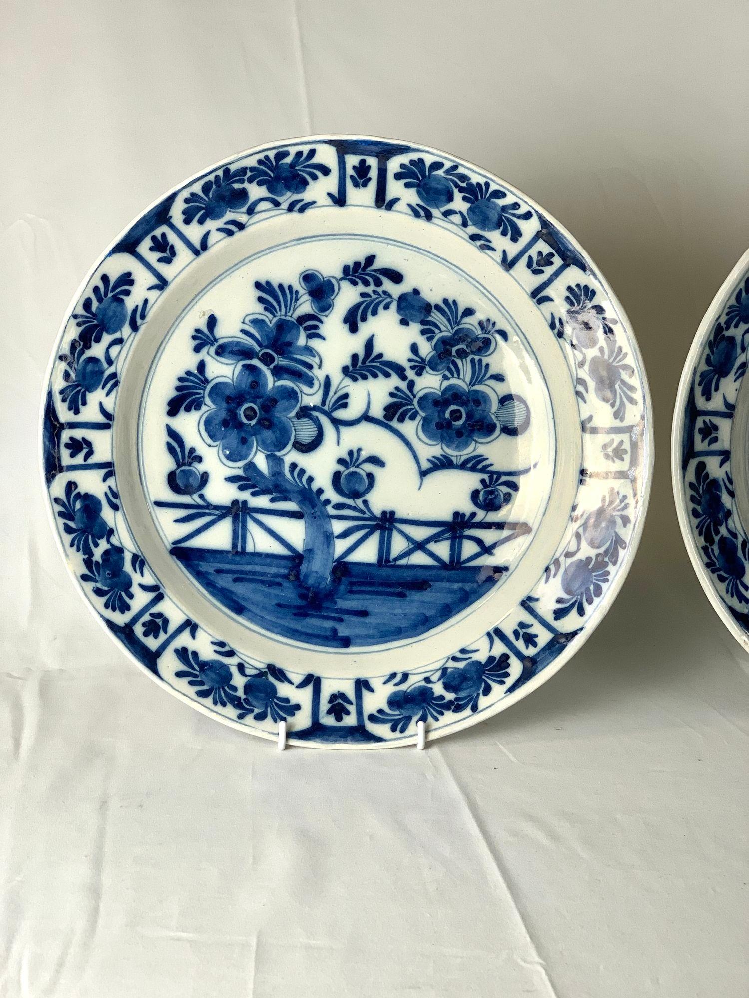 This pair of antique blue and white Dutch Delft chargers was hand-painted in the 18th century, circa 1780.
The deep cobalt pigment, characteristic of high-quality Delftware, is used to create bold floral and foliate forms with delicate shading and