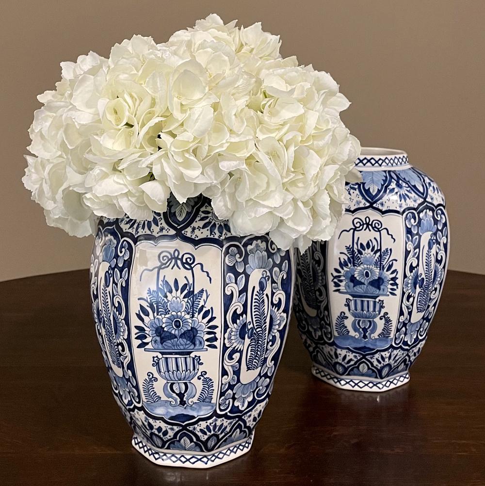Pair 19th Century Boch hand-painted blue & white vases make a splendid accent as well as a vessel for fresh flowers or other decorative items! The intricate combination of patterns encircle each vase, alternating on the facets, with stylized