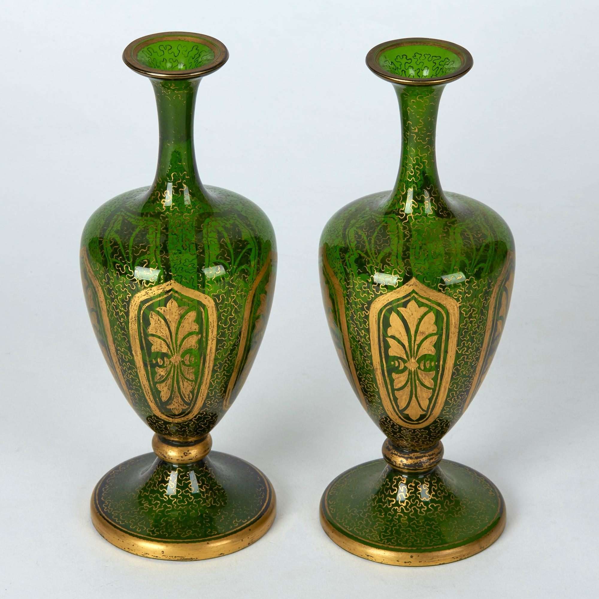 A very fine antique pair Bohemian green glass vases decorating with gilding, possibly Moser dating from the latter 19th century. The beautifully made vases stand on a rounded pedestal base with knop stem supporting a pear shaped body with tall