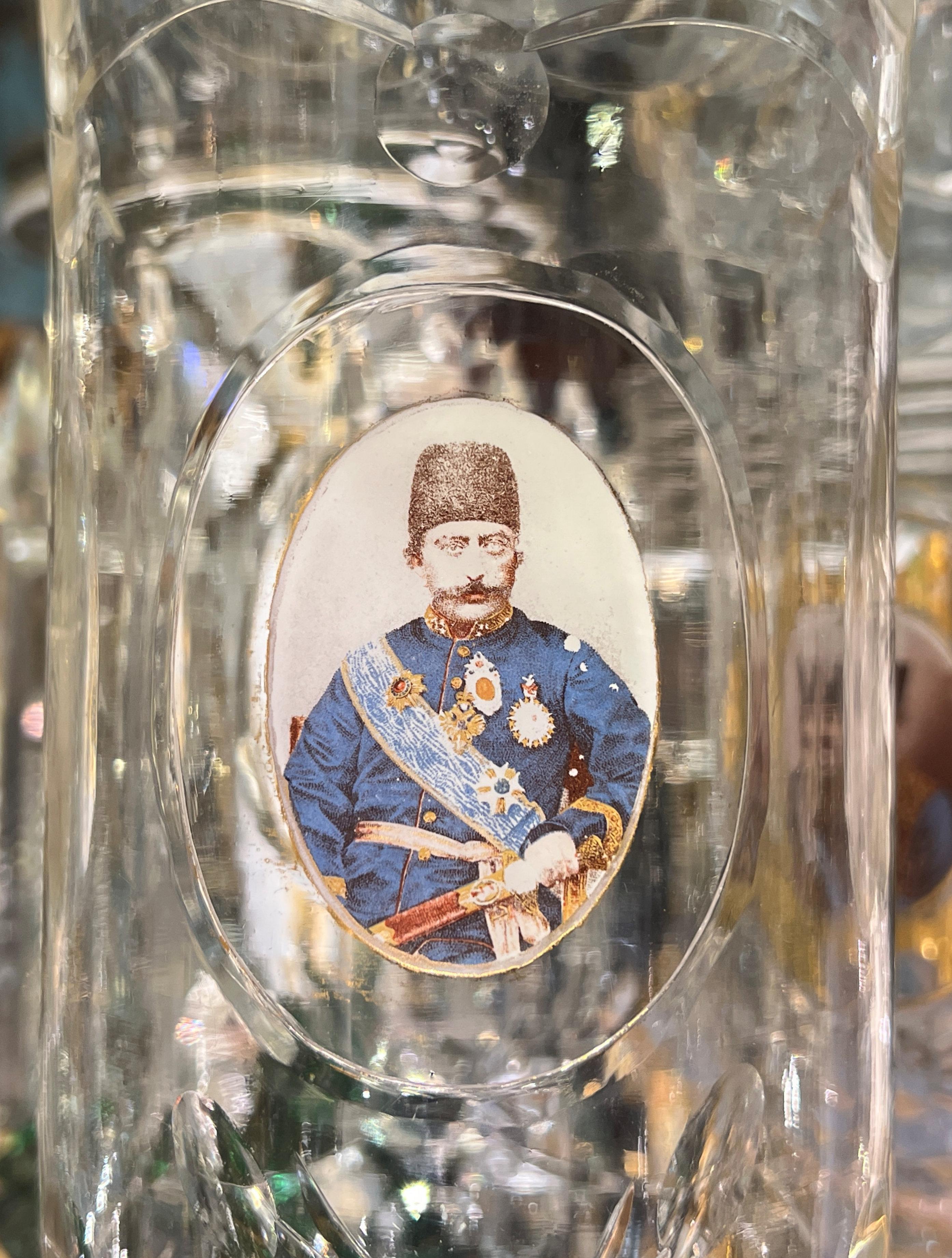 Pair of antique (late 19th to early 20th century) gilt and enameled glass lusters made for the Persian market, with matched pair of hurricane shape shades depicting Mozaffar al-Din, Shah from 1896 to 1907.  Each over 23 inches tall.