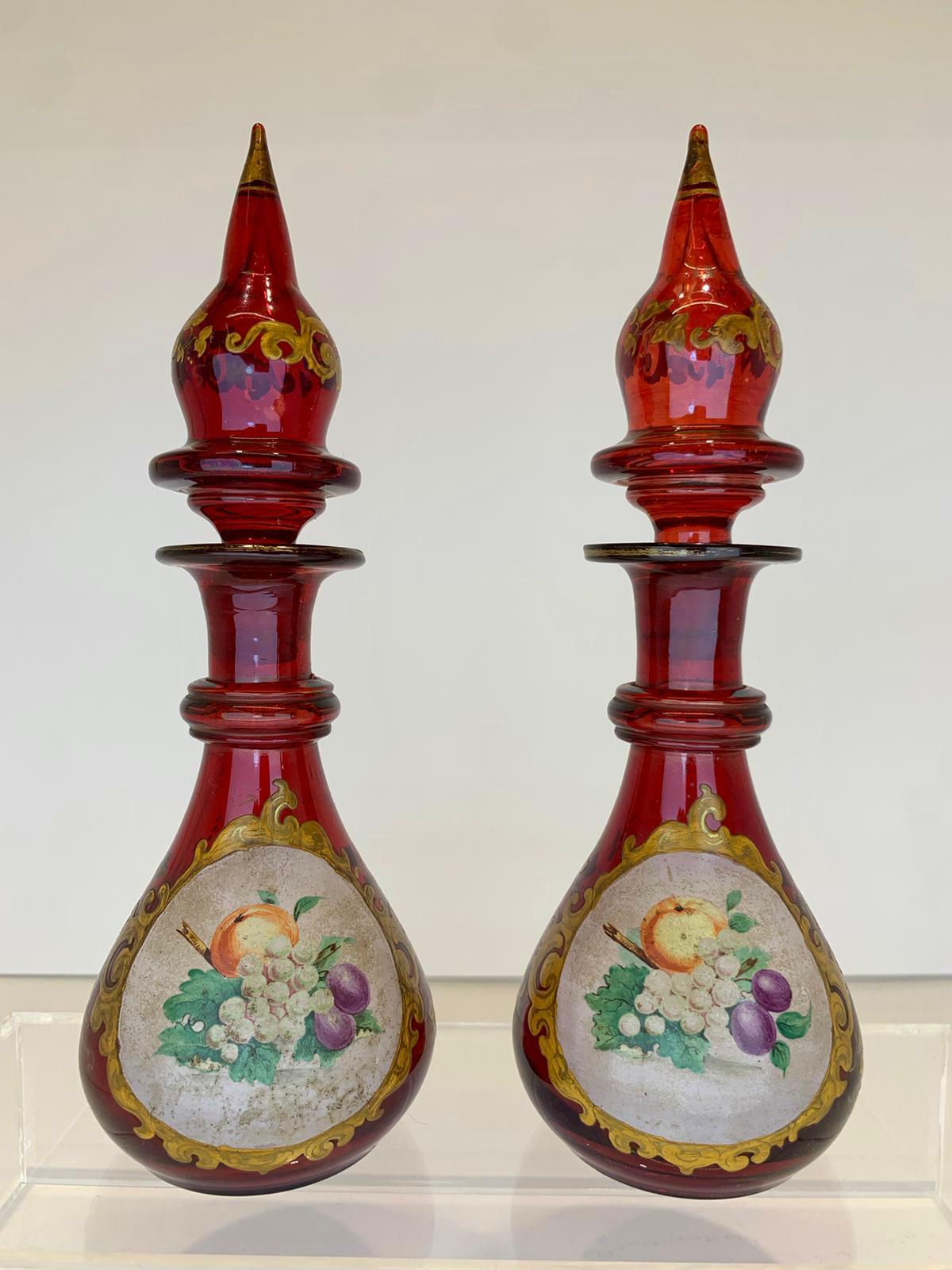 Bohemian blown glass perfume bottles and stoppers in ruby red color
decorated with gilded enamelled decoration
opaque glass overlay hand-painted with colorful fruit
Bohemia, 19th century.