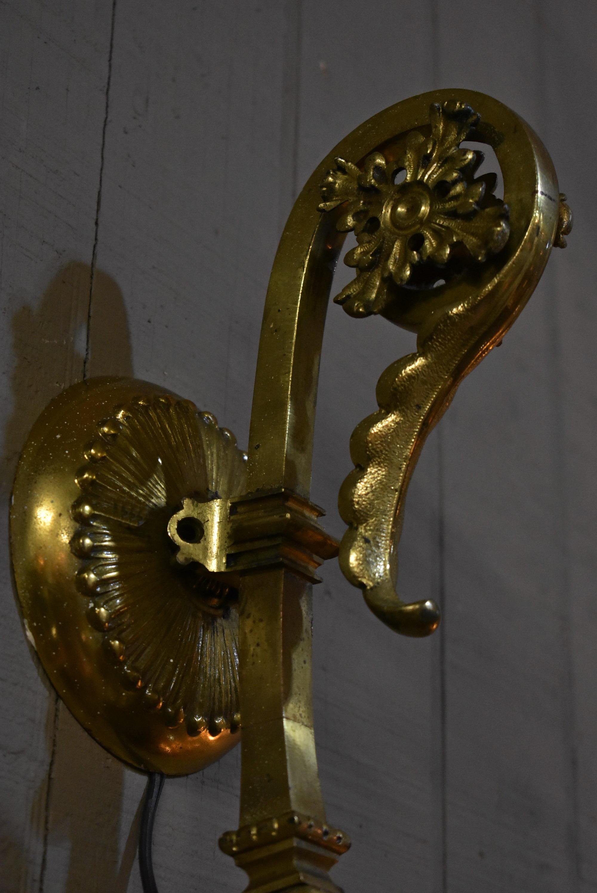 Pair of antique heavy brass ornate wall sconces. Grape design details on cut and polished astral shades.