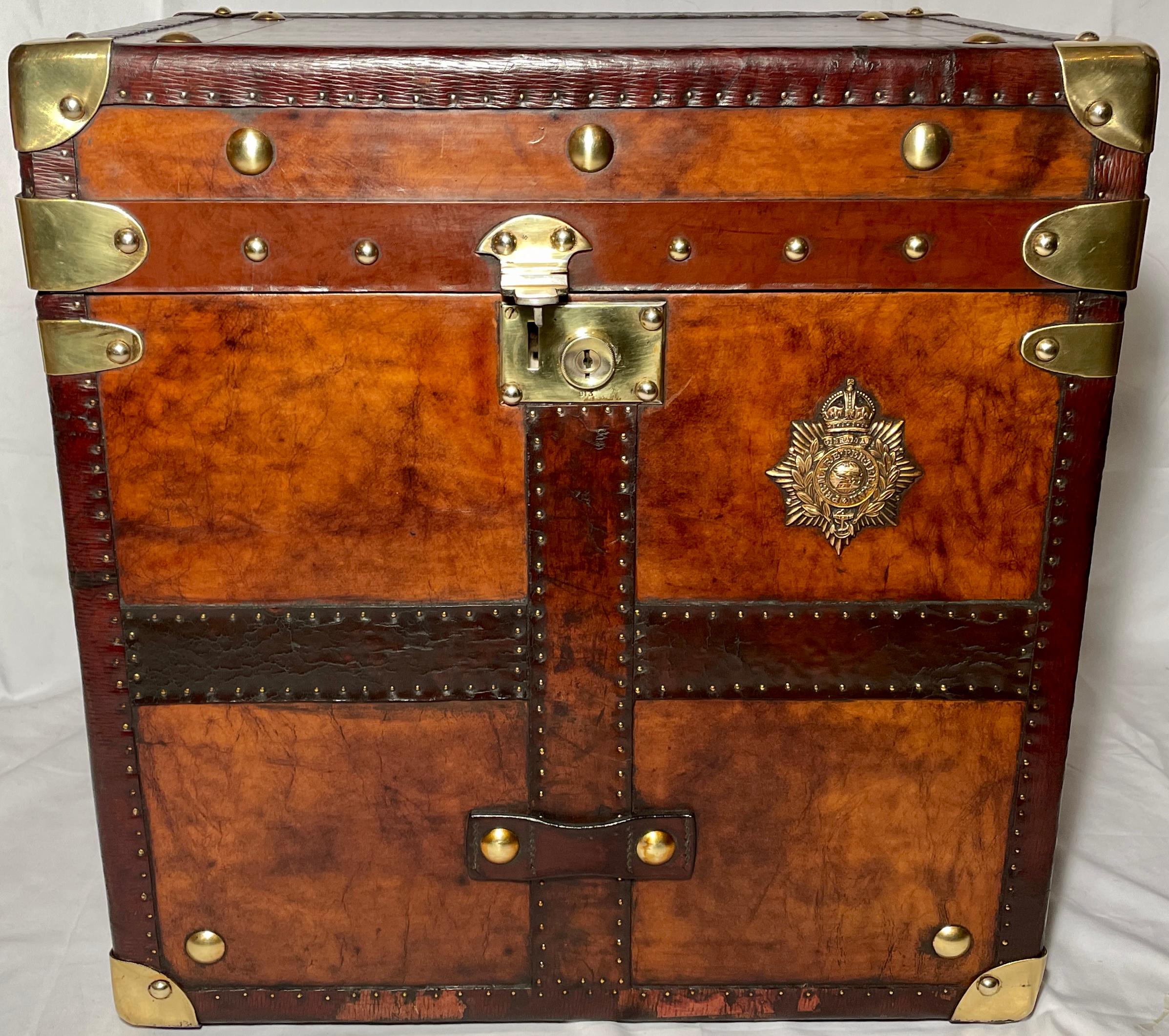Pair antique British military leather trunks. Brass badge is of the Royal Coat of Arms. Infantry battalion representing the home counties of the brigade. 