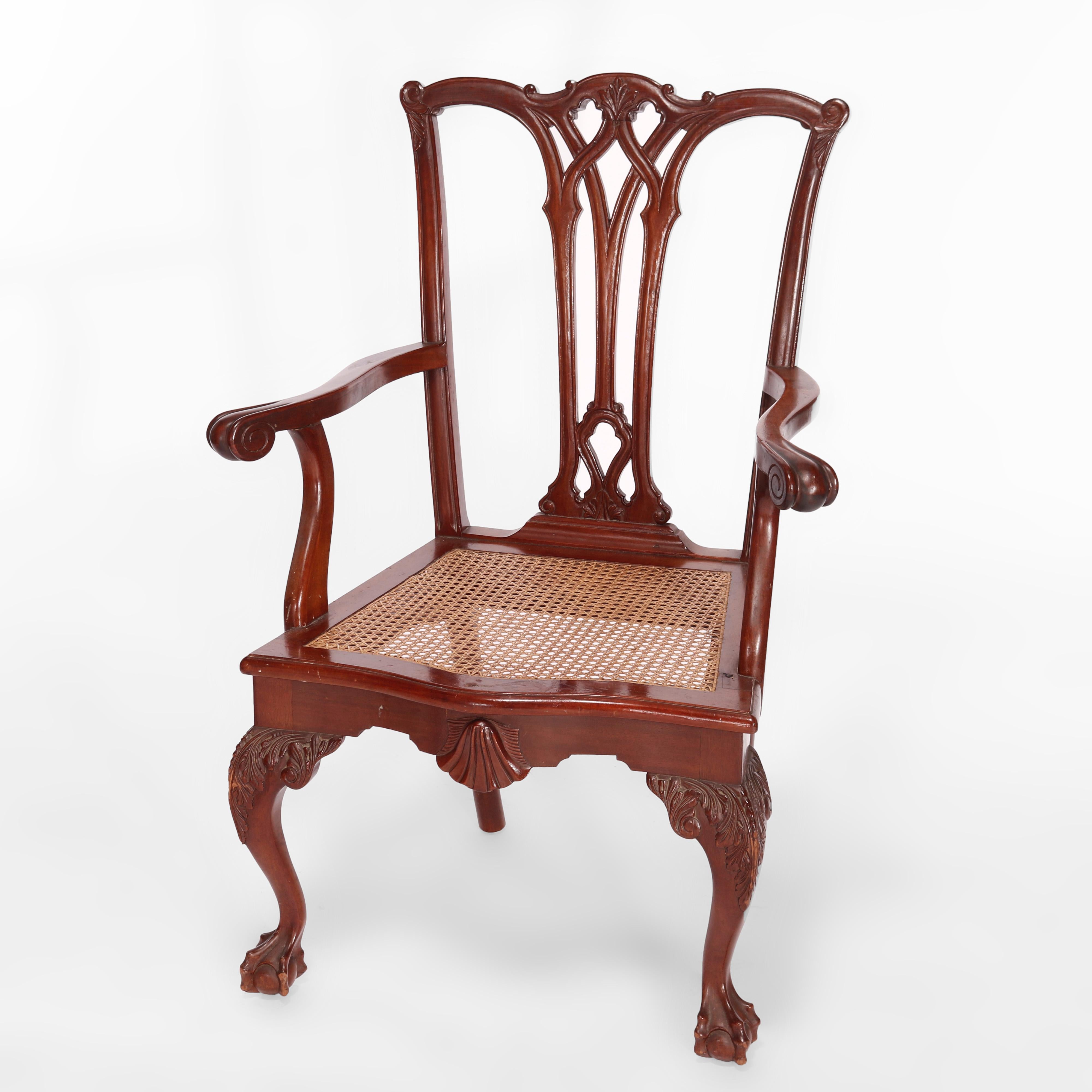 An antique pair of Chippendale style arm chairs offers mahogany frames with ribbon backs over upholstered seats raised on cabriole legs with carved acanthus knees and terminating in claw and ball feet, c193073660 - TW pair 

Measures- 41''H x