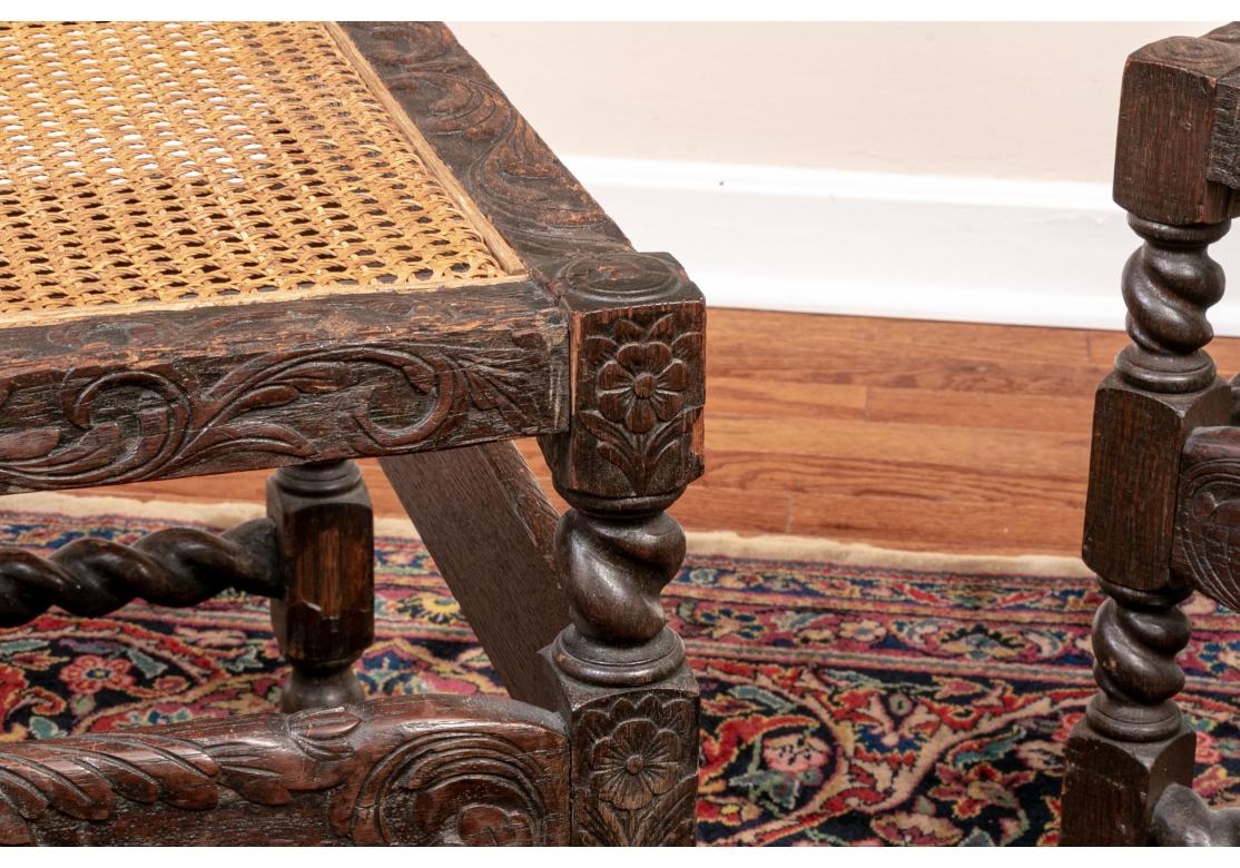 A pair of remarkable late 18th/ early 19th century European carved oak benches with foliate and barley twist elements. The frames well-carved with foliate scrolls and flowers on the tops and the flat front and back panels. Raised on barley twist