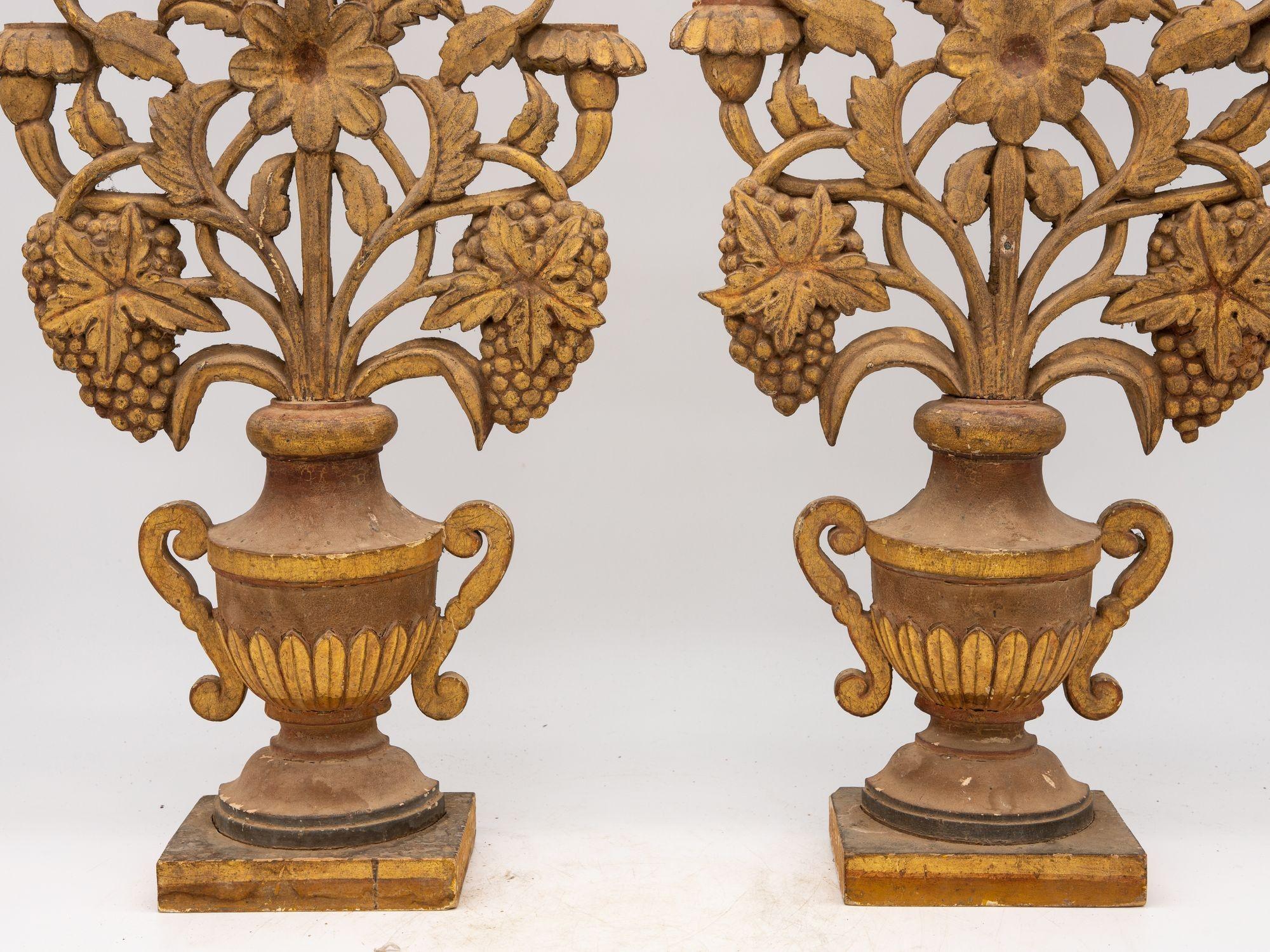 

Exquisite and unusul, this pair of antique carved wooden urns from late 19th century France captivates with its timeless elegance. Standing as delicate mantle ornaments, each urn showcases meticulous craftsmanship, portraying intricate floral