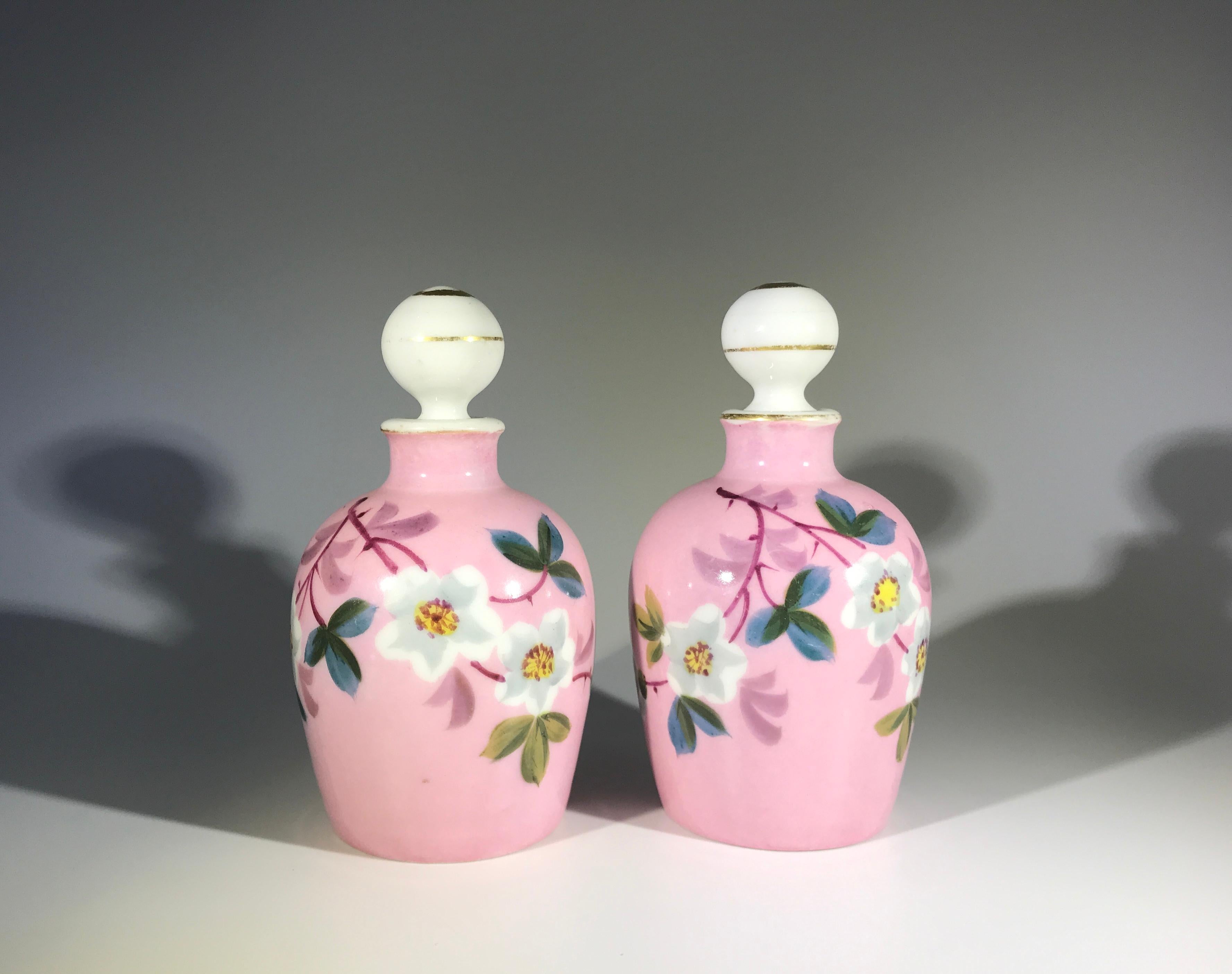 Charming pair of hand painted Charles Fields Haviland, Limoges antique porcelain perfume bottles, dating from the 19th century
Decorated with white cherry blossom flowers on a delicate pink background
The stoppers are white with gilded