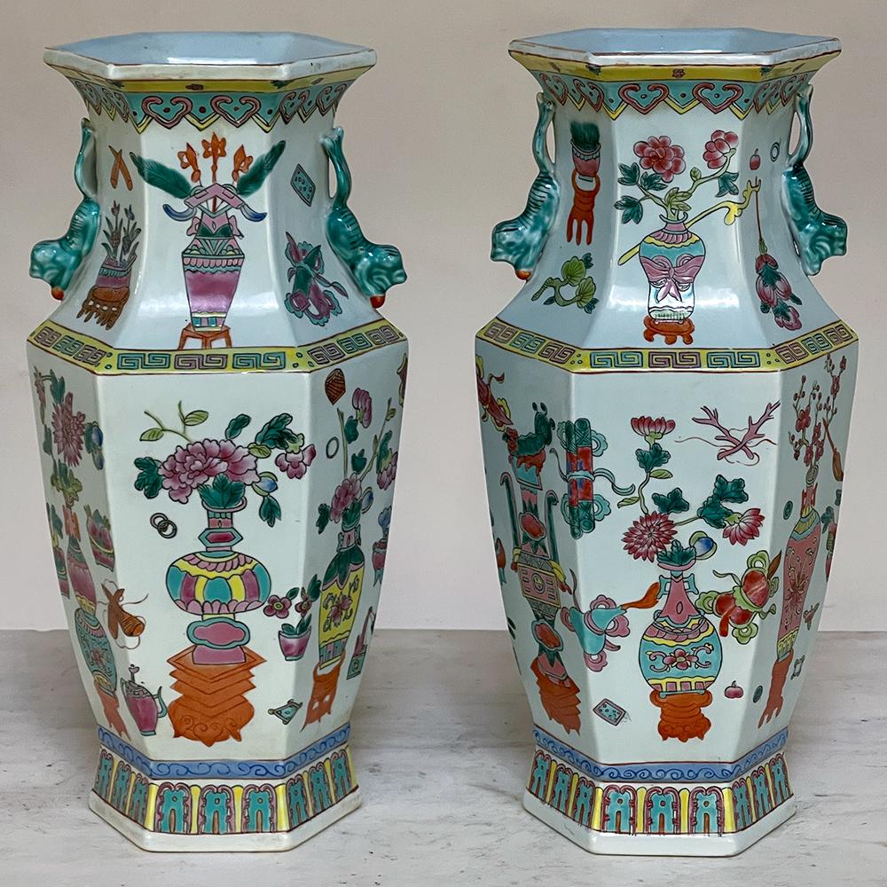 Pair antique Chinese hand-painted vases will make a colorful addition to your decor. Using several shades of green combined with blue and a brick red, a scene of entertaining at the court is depicted, with flowers, foliates and geometric designs