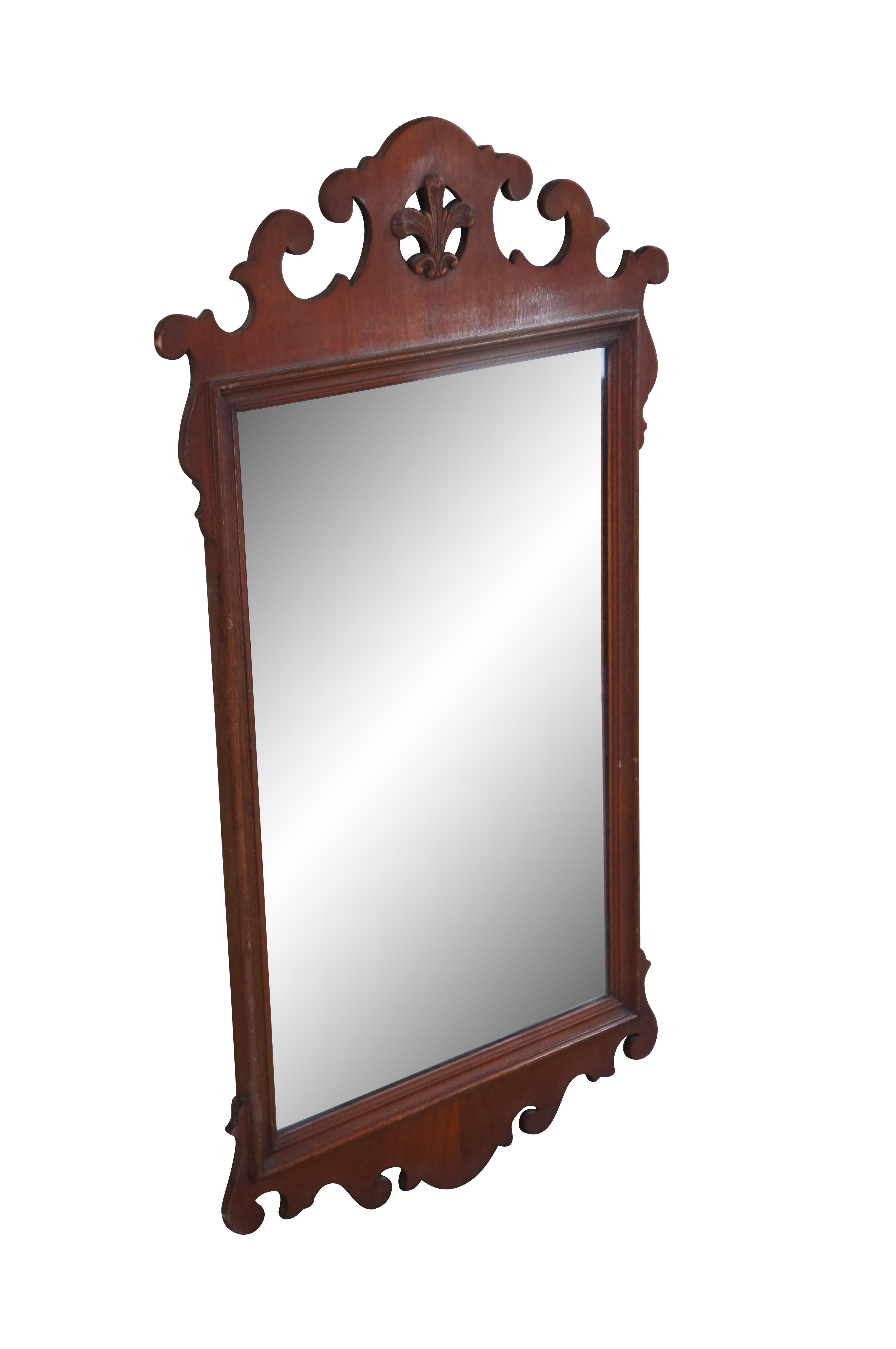 A lovely set of early 20th century Federal / Chippendale Style mirror.  Features mahogany finished frames with carved and scrolled designs.  At the center of each along the top is a pierced medallion with Prince of Wales feathers. 