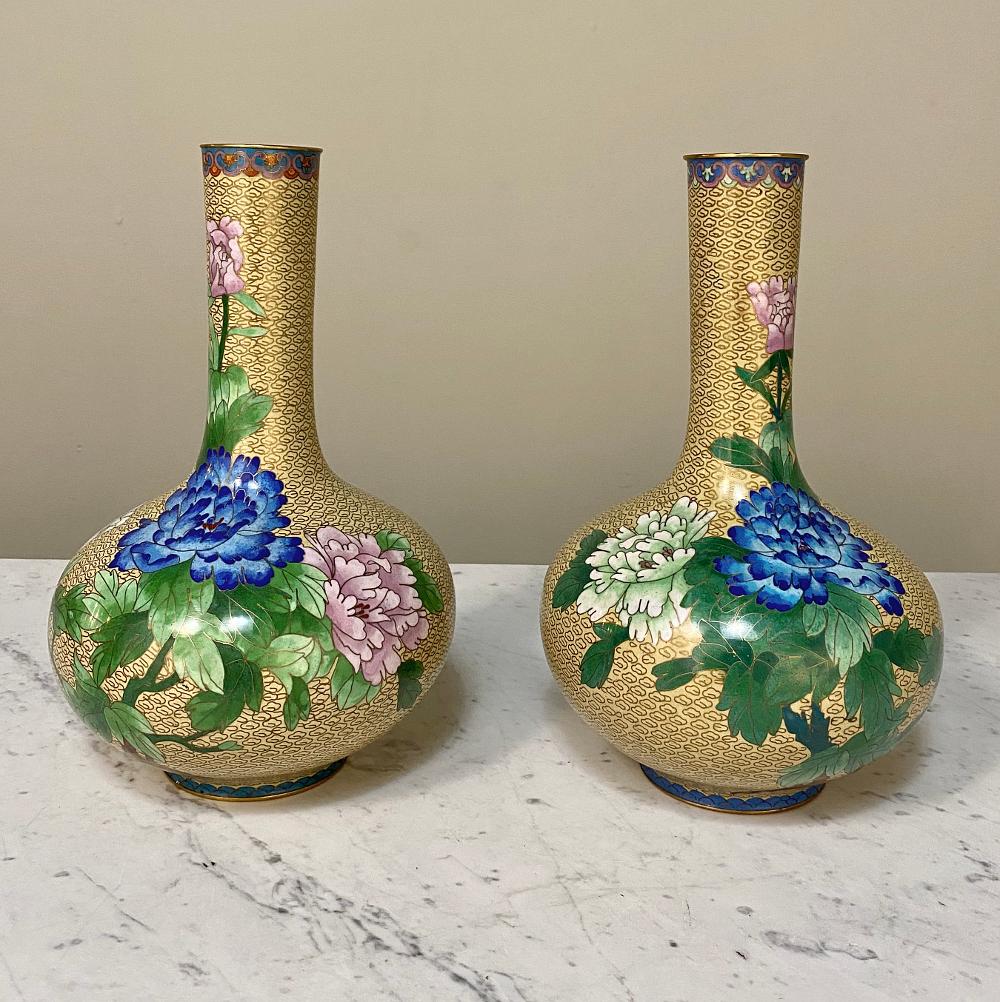 Pair of antique cloisonné vases are a beautiful way to add color and form to your decorating scheme! Made from brass, each has been carefully overlaid with brass wire soldered onto the surface, creating a raised art form that is then filled with