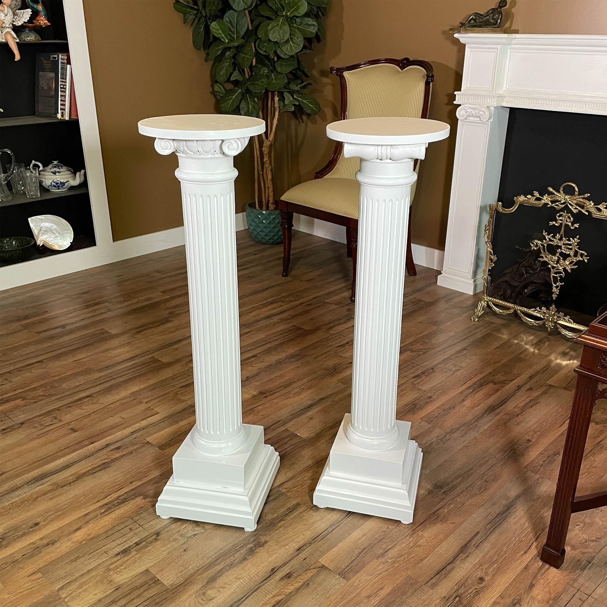 A PAIR Antique Corinthian Pedestals featuring beautifully detailed carving and fluting. Created more than 100 years ago these pieces have withstood the test of time in structurally good condition and have recently been painted to give them a fresh
