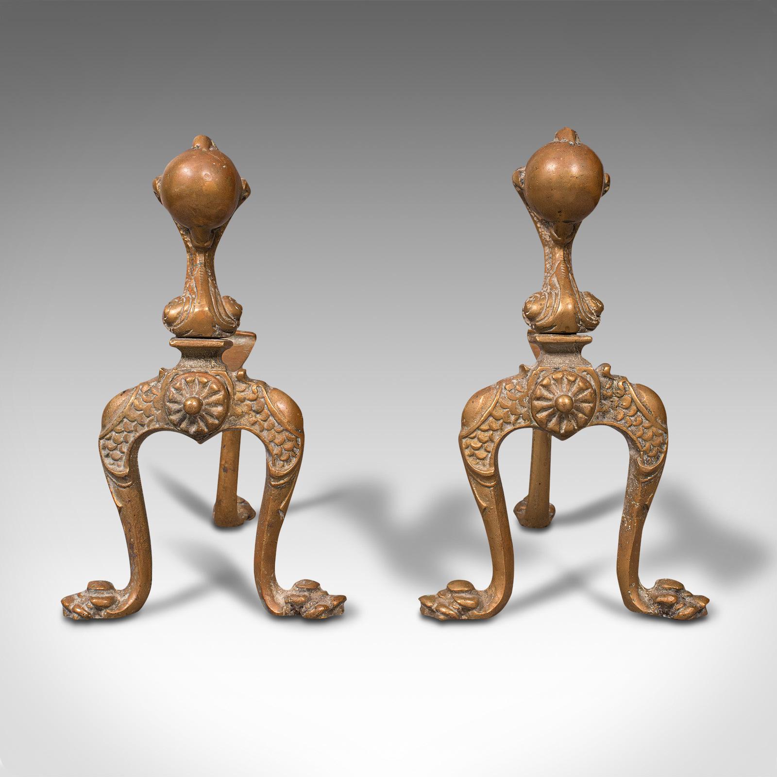This is a pair of antique decorative fireside tool rests. A French, brass andiron or fire dog, dating to the Victorian period, circa 1880.

Striking decorative appeal and great colour
Displaying a desirable aged patina
Lightly weathered brass
