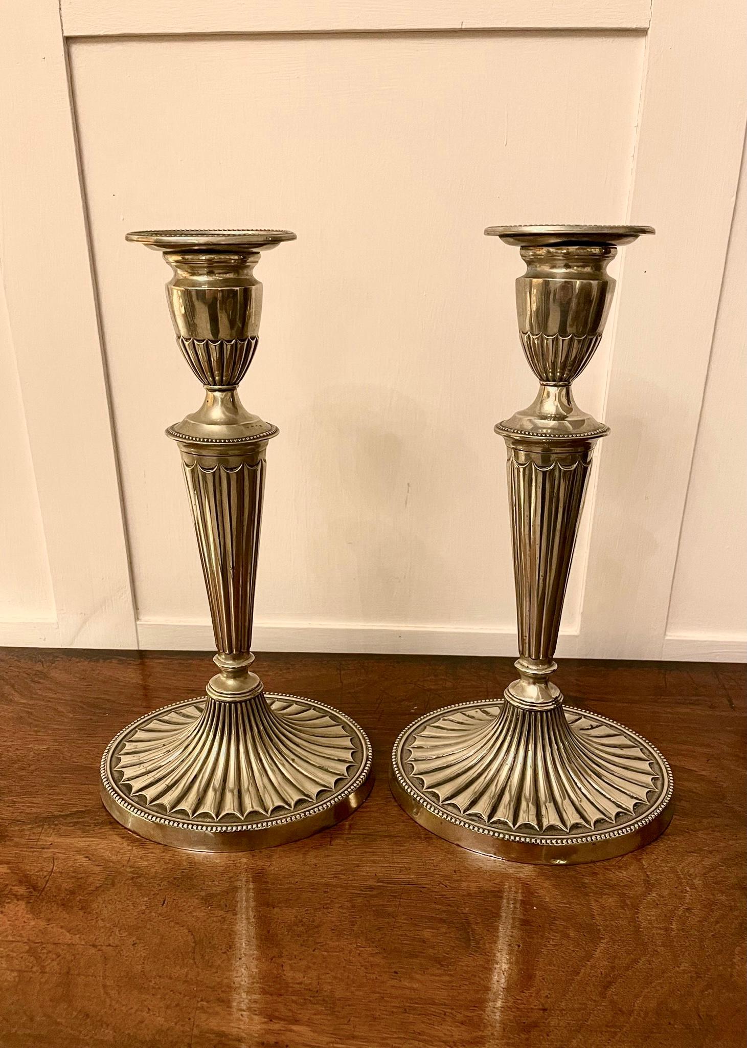 Pair antique Edwardian silver painted candlesticks having circular tops and ornate fluted columns on oval ornate fluted shaped bases.

28 x 15 x 12cm
Date 1900.
 
