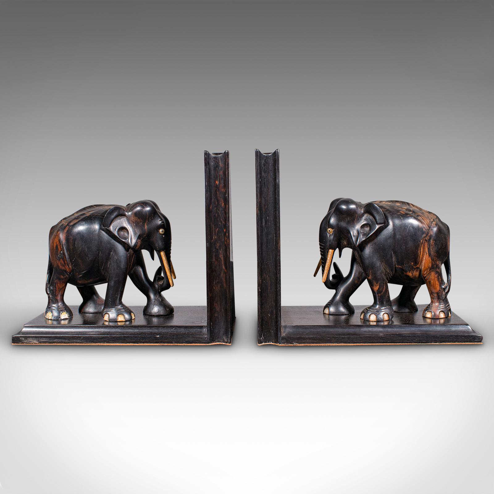 
This is a pair of antique elephant bookends. An Indian, coromandel decorative novel or book rest, dating to the late Victorian period, circa 1900.

Offering charming character and display appeal for the reader
Each displaying a desirable aged