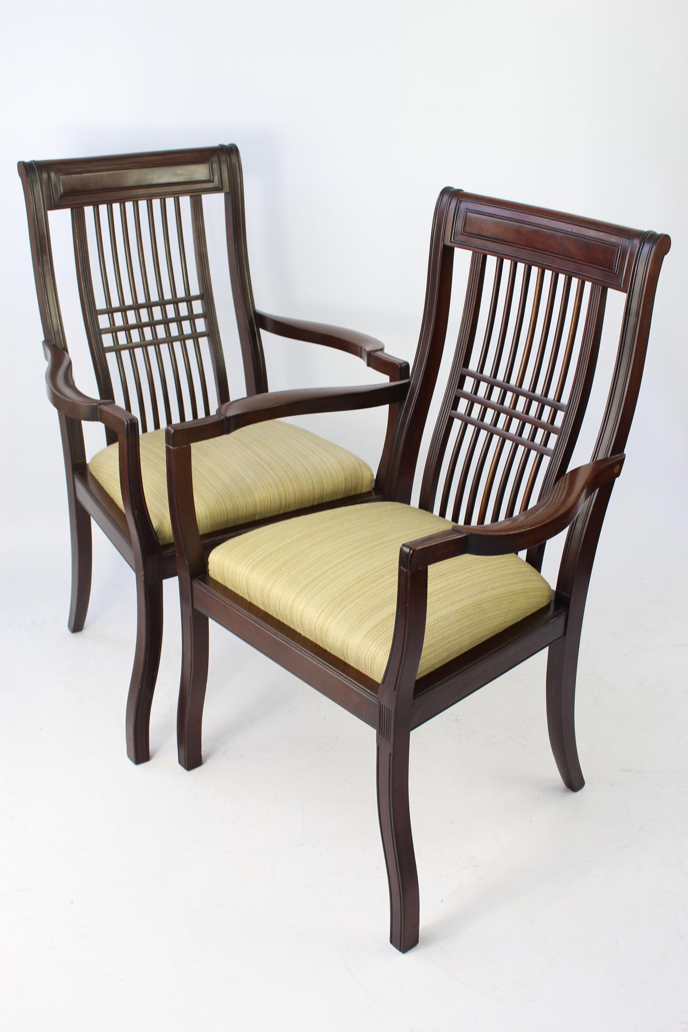 A very stylish pair of antique Edwardian mahogany Arts and Crafts open armchairs dating from circa 1910. With lattice backs and tablet back top rail, curved arm supports and serpentine legs. The drop-in sprung seats have been newly reupholstered. In