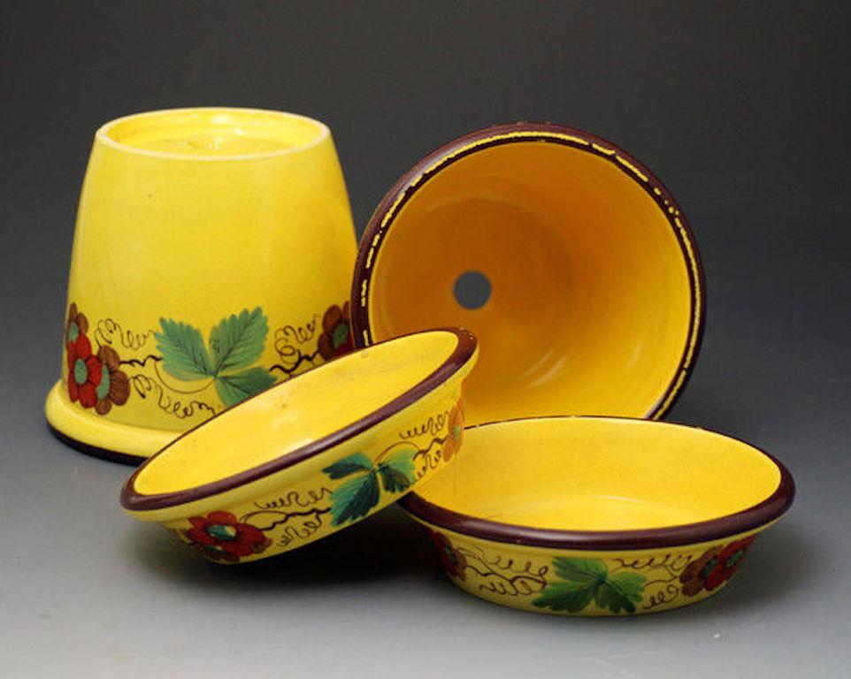 A fine antique pair of canary yellow pottery jardinieres complete with original trays.
They are strongly decorated with flowers and leaves in bright enamels. The yellow ground is a wonderful egg yolk color giving decorative impact.
Rare survivors,