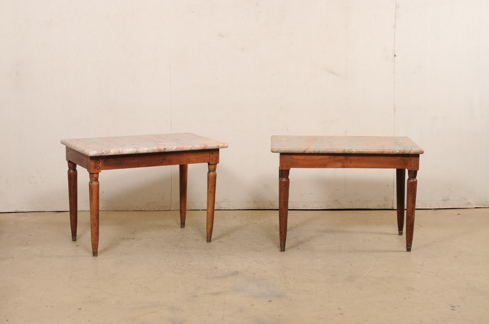 An English pair of marble top occasional tables from the 19th century. These antique tables from England each retain their original, rectangular-shaped marble tops (which are quite beautiful) with softly rounded edges and corners. The marble