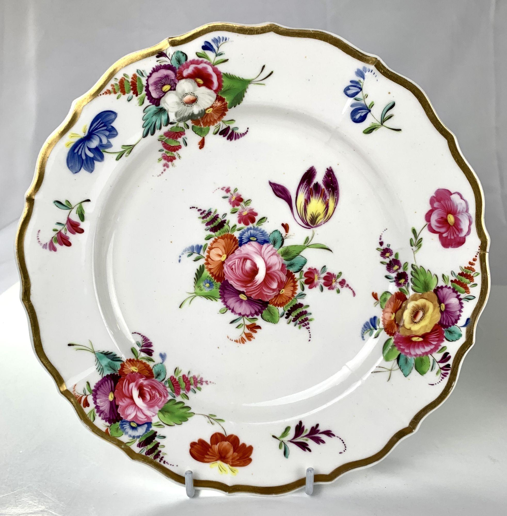 This pair of dishes were hand-painted at Coalport in England in the early 19th century. 
The colors are fabulous; we see pink, purple, orange, blue, green, yellow, and turquoise.
Flowers are everywhere; beautiful roses, forget-me-nots,