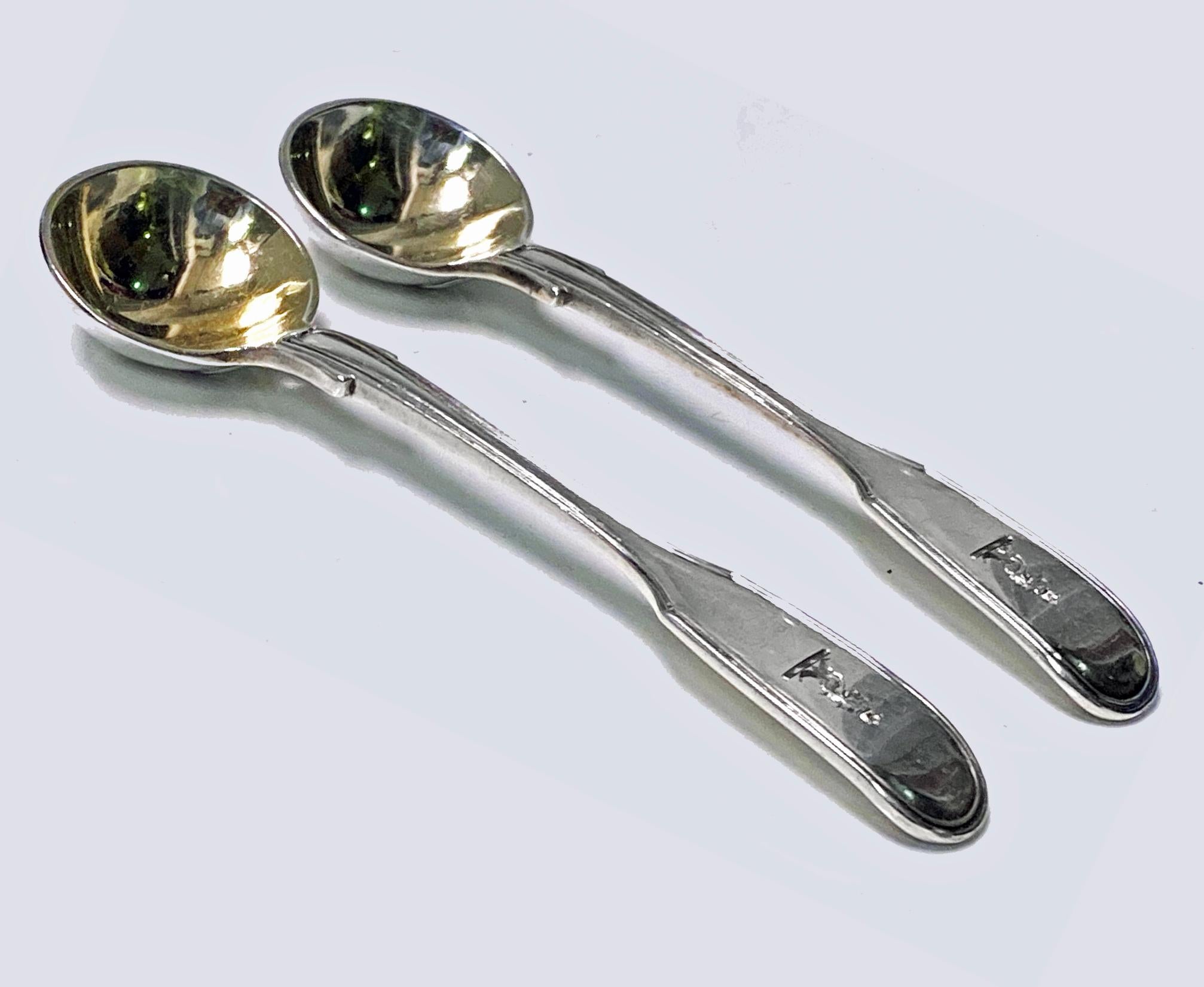 Pair Antique English Silver master Salt Spoons London 1832 Lias Bros. Fiddle pattern, each engraved with crest of lion’s head erased with ducal coronet, gilded bowls. Length: 4.25 inches. Weight: 52.70 grams. Condition: Good. Reflections in bowls