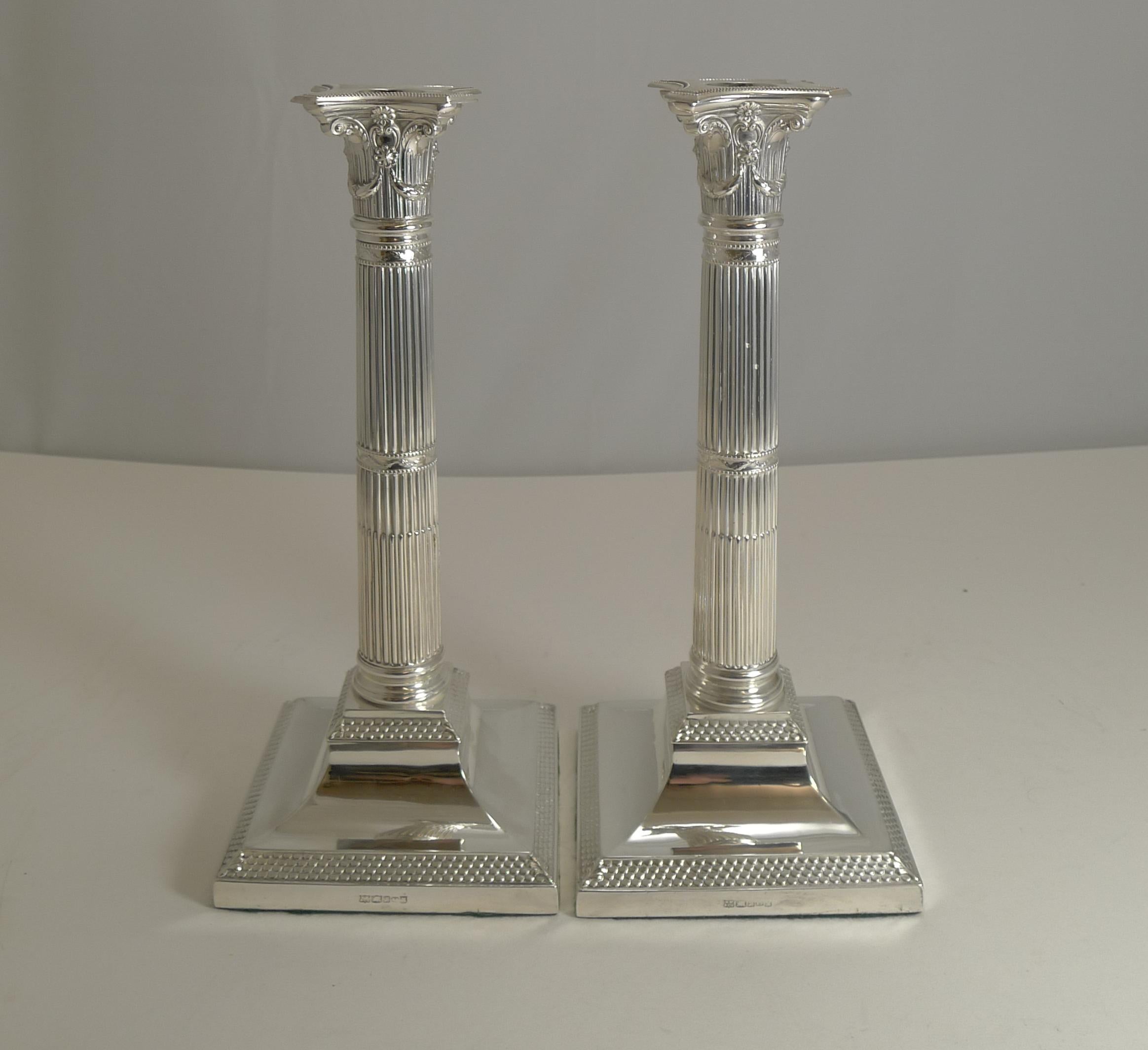 A very handsome pair of late Victorian Corinthian column candlesticks with an unusual design to the base; lovely to see something slightly different.

Each of the bases is fully marked MW & Co. for Mappin and Webb, the underside has been recently