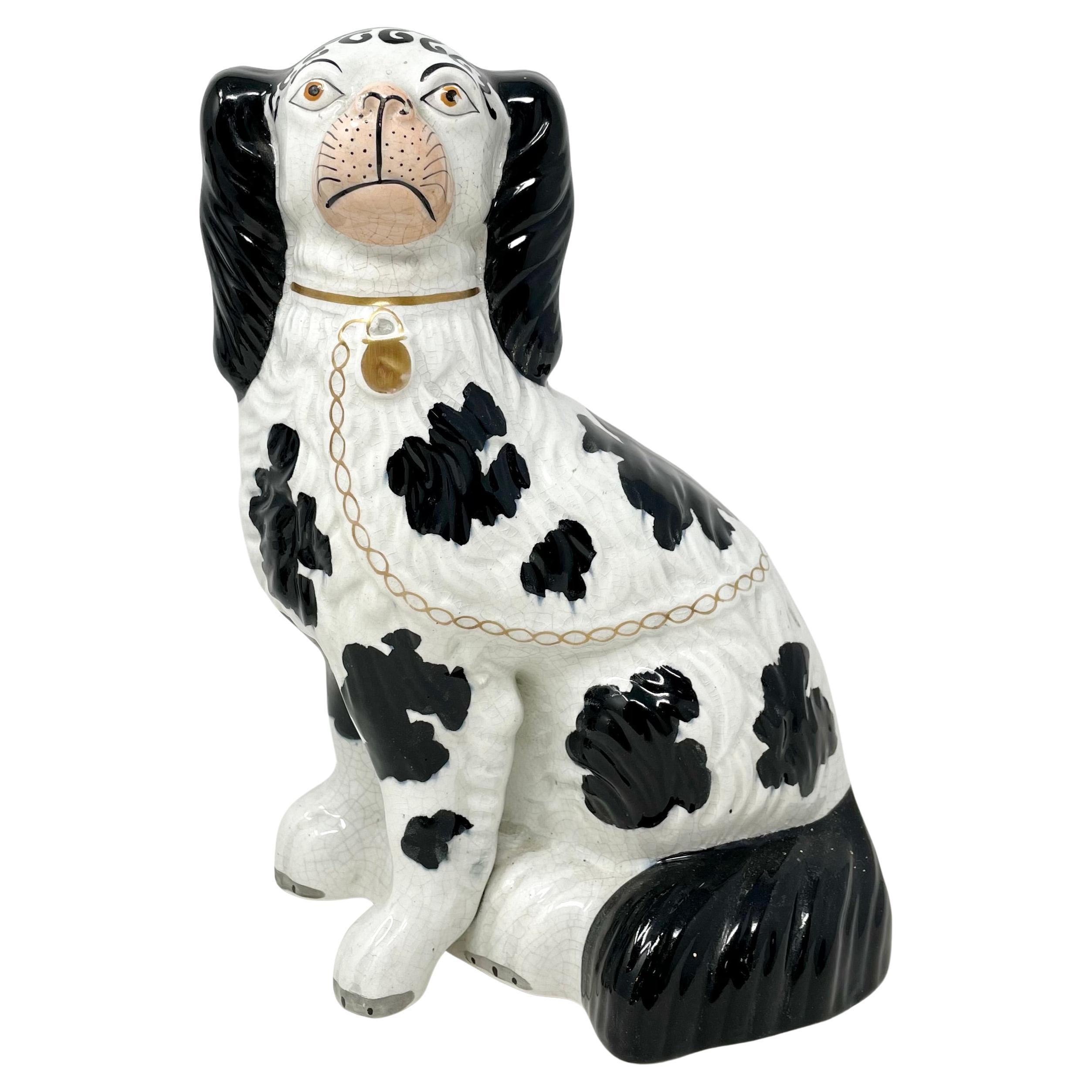 Pareja de spaniels sentados en blanco y negro de cerámica inglesa antigua de Staffordshire, hacia 1870-1880.