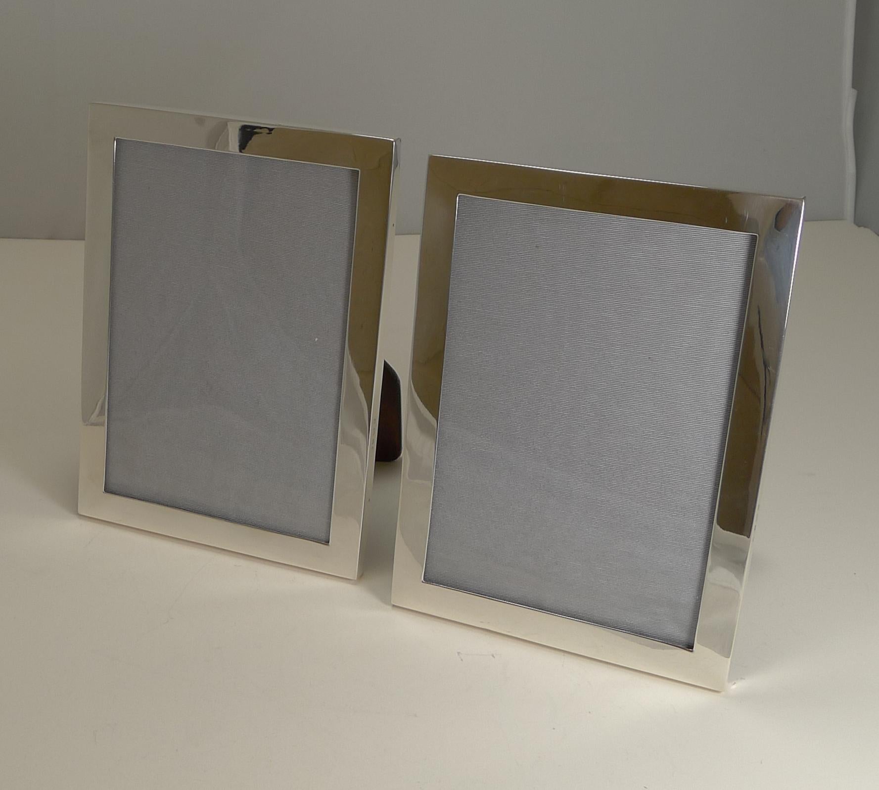 A very smart pair of antique English silver photograph frames with a plain and simple design, perfect to fit into any interior, from traditional to ultra-modern.

Made from sterling silver, both are fully hallmarked for Birmingham 1914 together