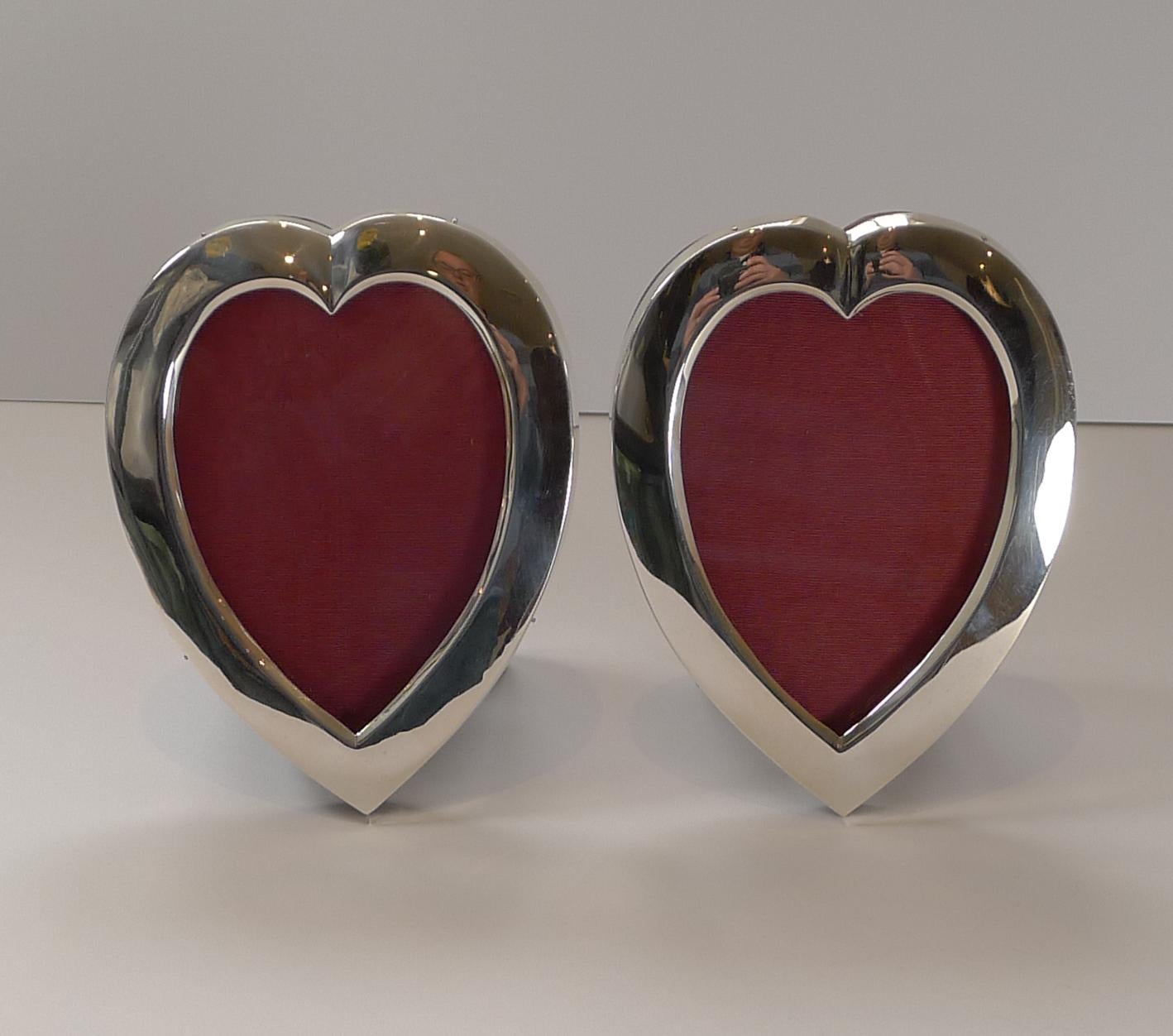 Wonderful to have a matching pair of heart shaped frames in solid sterling silver by the top notch silversmith, William Comyns each fully hallmarked for London 1896, a true Victorian pair.

The backs are made from solid English Oak with folding