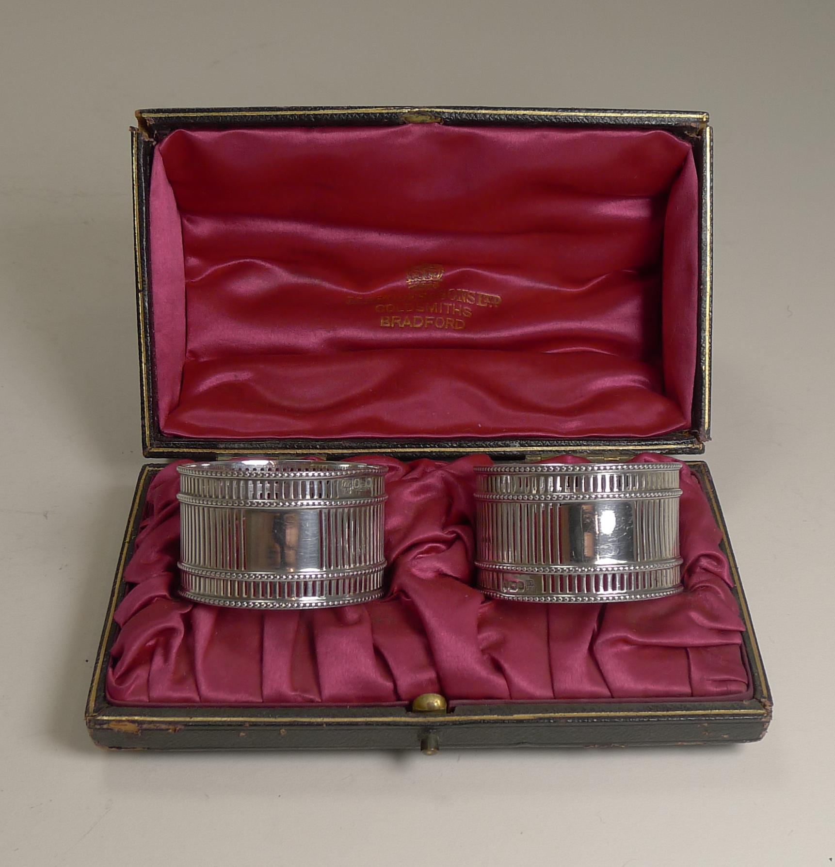 An unusual pair of Edwardian sterling silver napkin rings fully hallmarked for Sheffield 1902. The makers mark is also present for the silversmith, Hawksworth, Eyre & Co Ltd.

They have a simple pierced or reticulated design each with a vacant