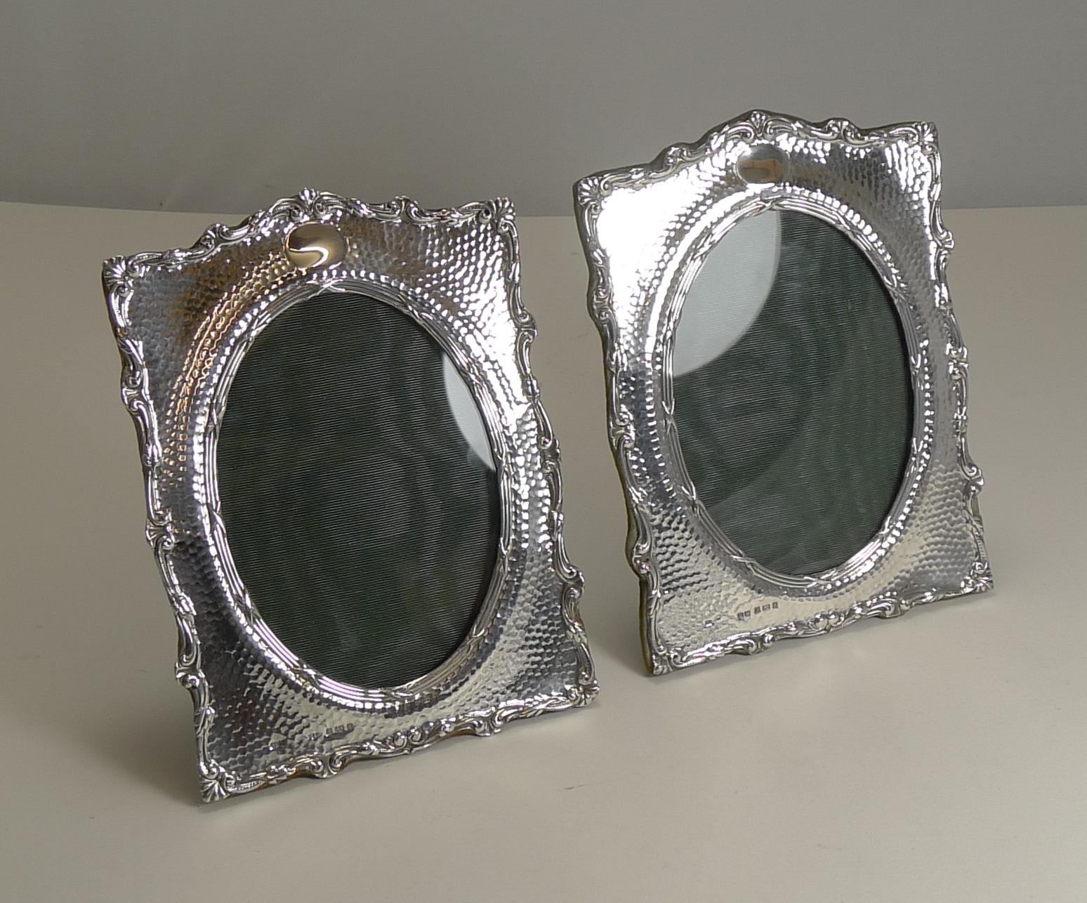 A fabulous pair of English Edwardian photograph frames by the well renowned silversmith, Henry Matthews.

The sterling silver has a planished background, the elegant shape of the frame with a pretty raised border; the oval aperture outlined by a