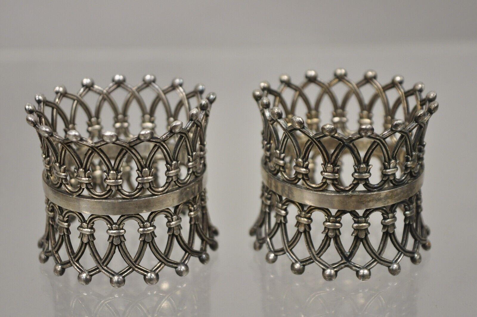 Pair of Antique English Victorian Silver Plate Pierced Fretwork Crown Napkin Rings. Item features an ornate pierced fretwork design, royal crown form, very nice antique pair. Circa Early 1900s. Measurements: 2