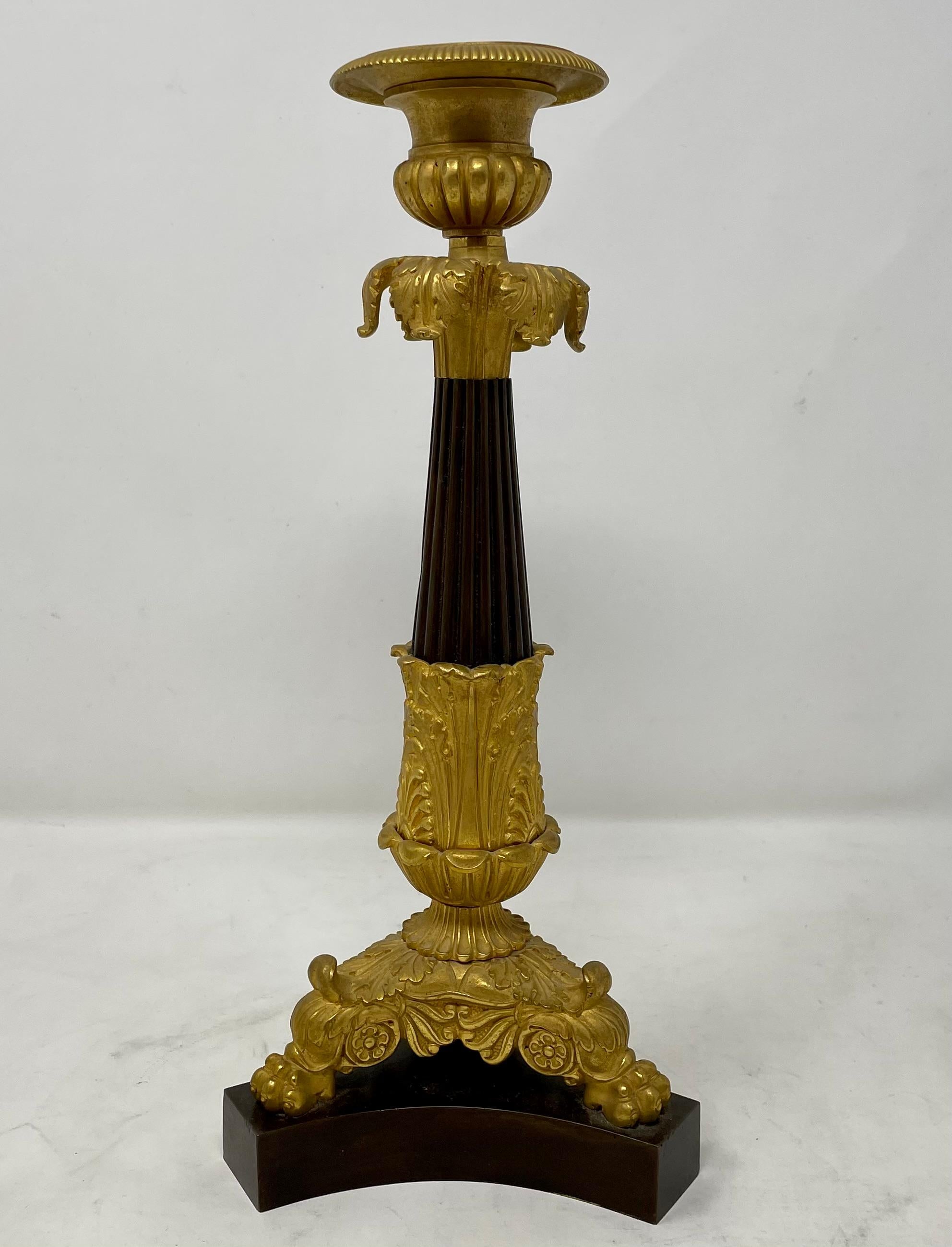 Pair Antique French Charles X gold bronze and patinated bronze candlesticks, Circa 1880.