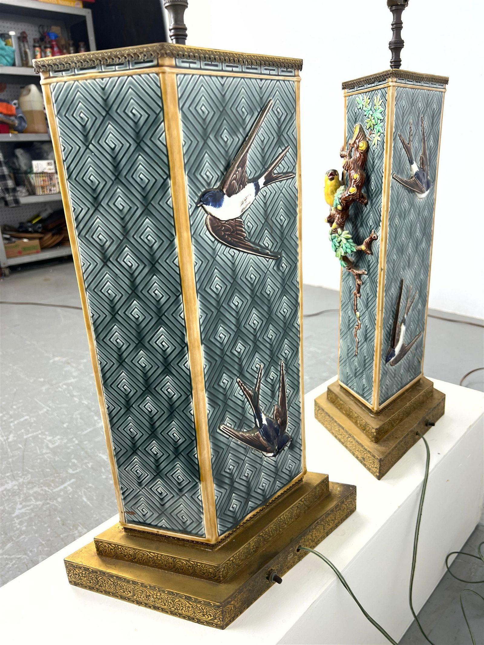 Pair of unique antique (early 20th century) polychrome glazed earthenware (faience) vases mounted on brass pedestals for use as table lamps, featuring 
song birds in relief on a lattice ground with various Asian motifs.  Possibly from Sarreguemines.