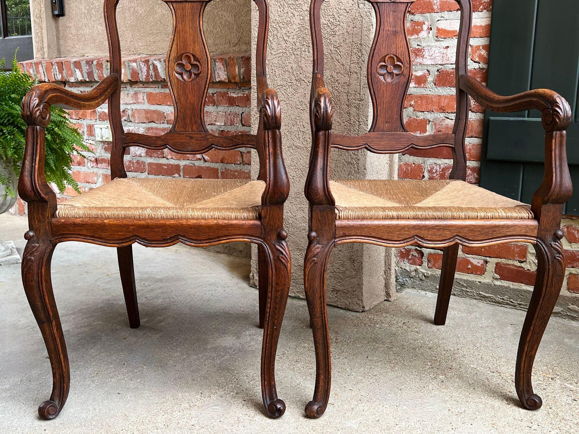 Early 20th Century PAIR Antique French Country Carved Oak Dining ARM Chair Rush Seat Set of 2 For Sale