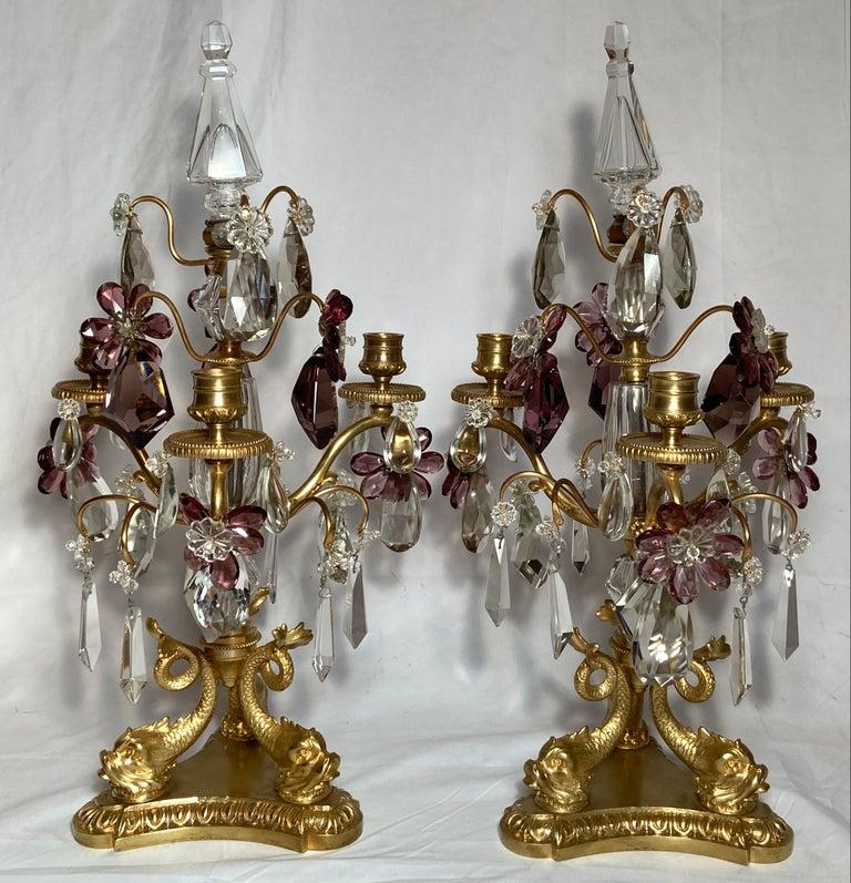 Pair antique French crystal and bronze candelabra, Circa 1890s. Purple and clear crystal polished prisms on a beautiful gold bronze figural Dolphin fish base.