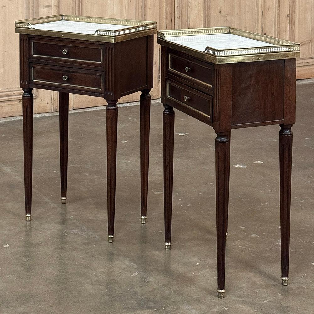 Pair Antique French Directoire Neoclassical End Tables with Carrara Marble are ideal companions for any setting.  Hand-crafted from exotic imported mahogany, each has been given a finish on all four sides making placement in the middle of the room