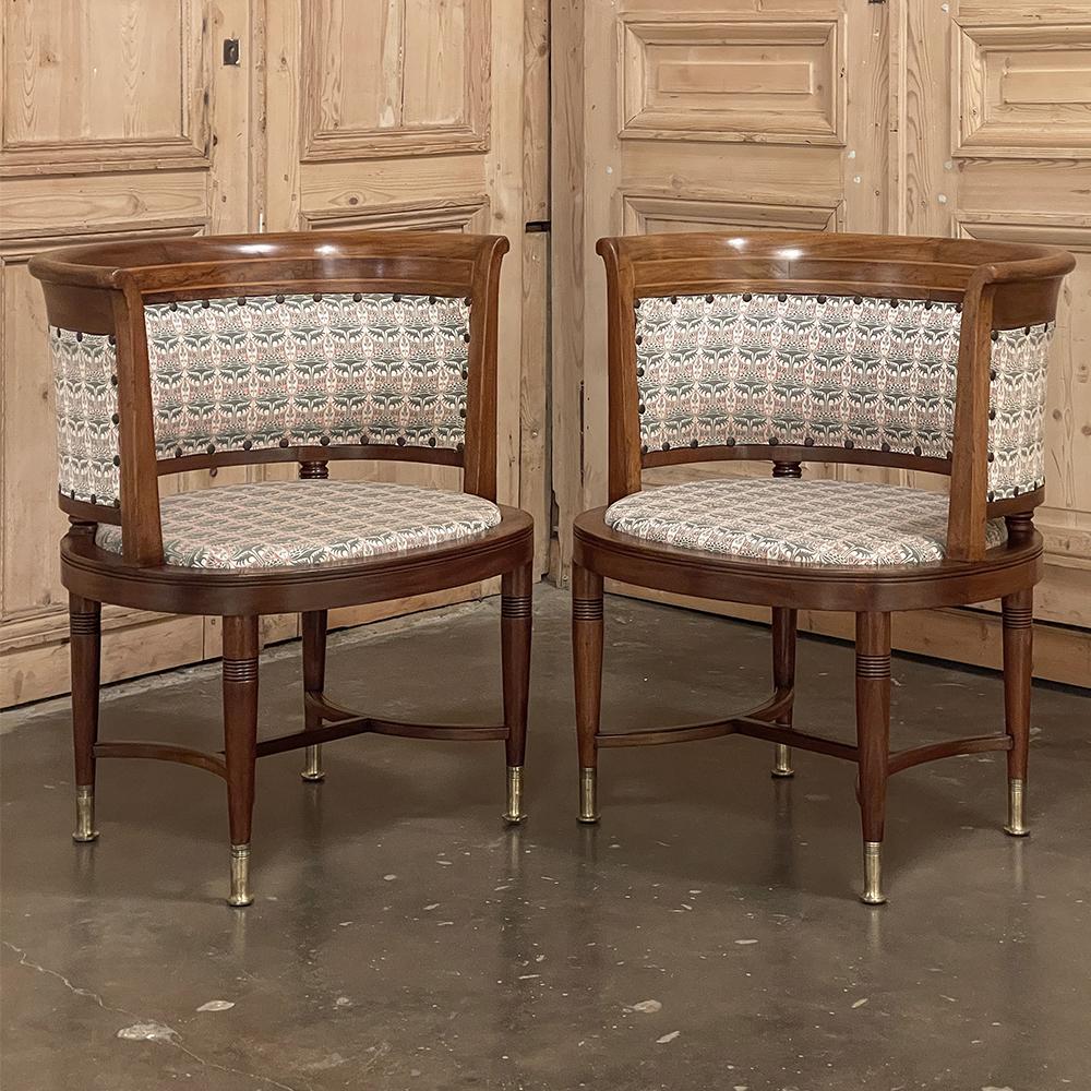 Pair antique French Directoire style Mahogany Armchairs feature the tailored, elegant lines of the design that has made it popular for two centuries! The wraparound seatbacks are flared outwards to present nothing but curved edges to one seated in