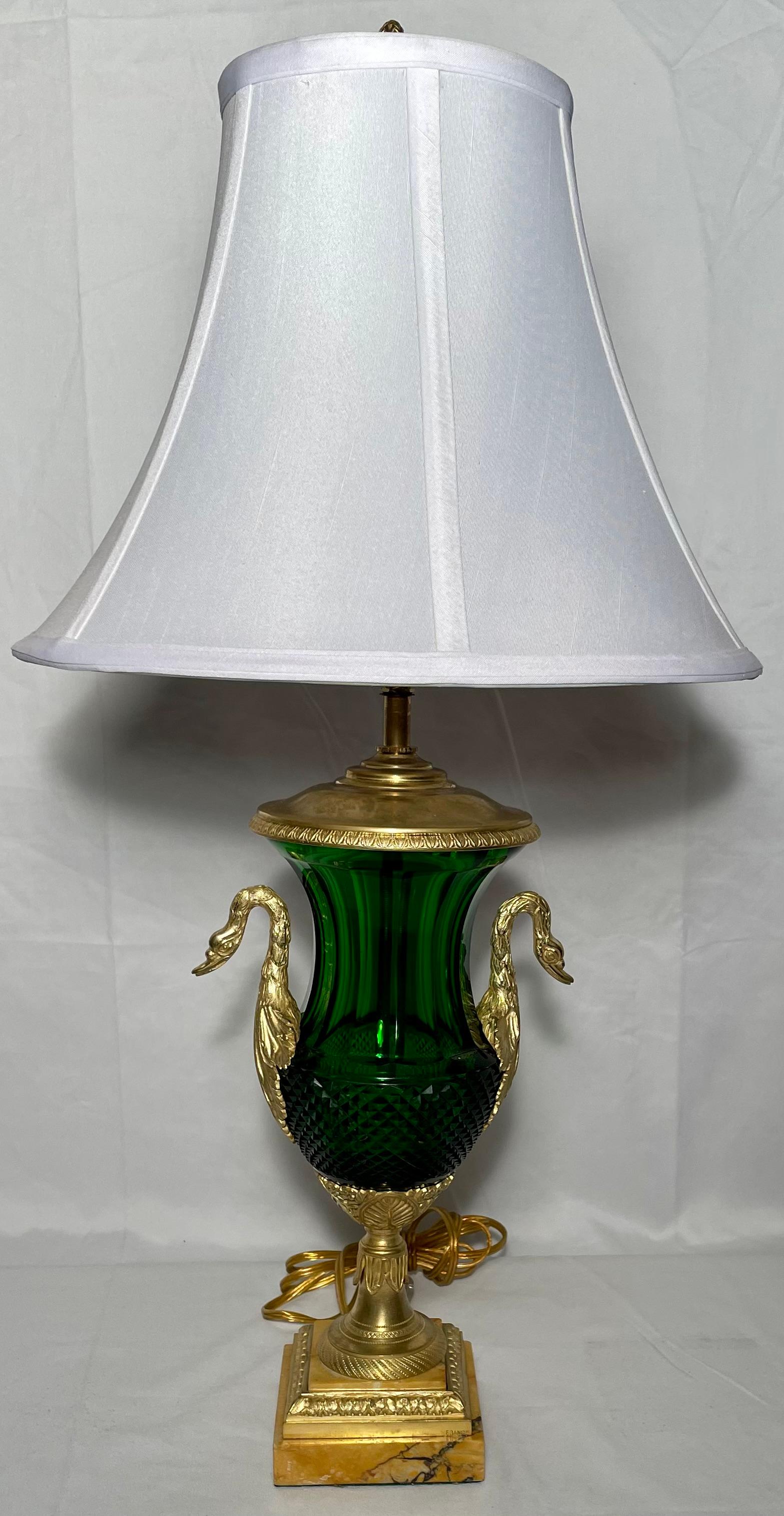Pair antique French emerald color baccarat crystal lamps with gold bronze mounts and marble bases, circa 1890-1900.