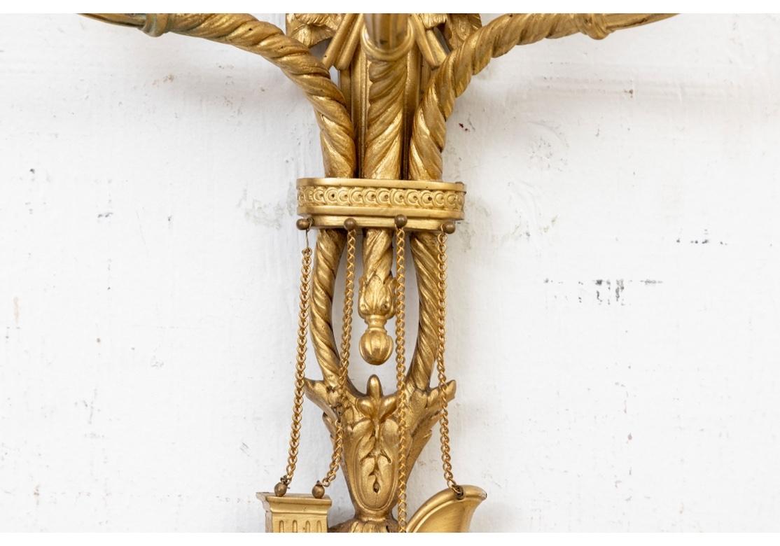 Tall three light electrified wall sconces with various decorative motifs top to bottom in a French inspired design. The eagle crest is perched atop clouds with an inscribed shield (to the stars) on the fluted support with four standing flags. The