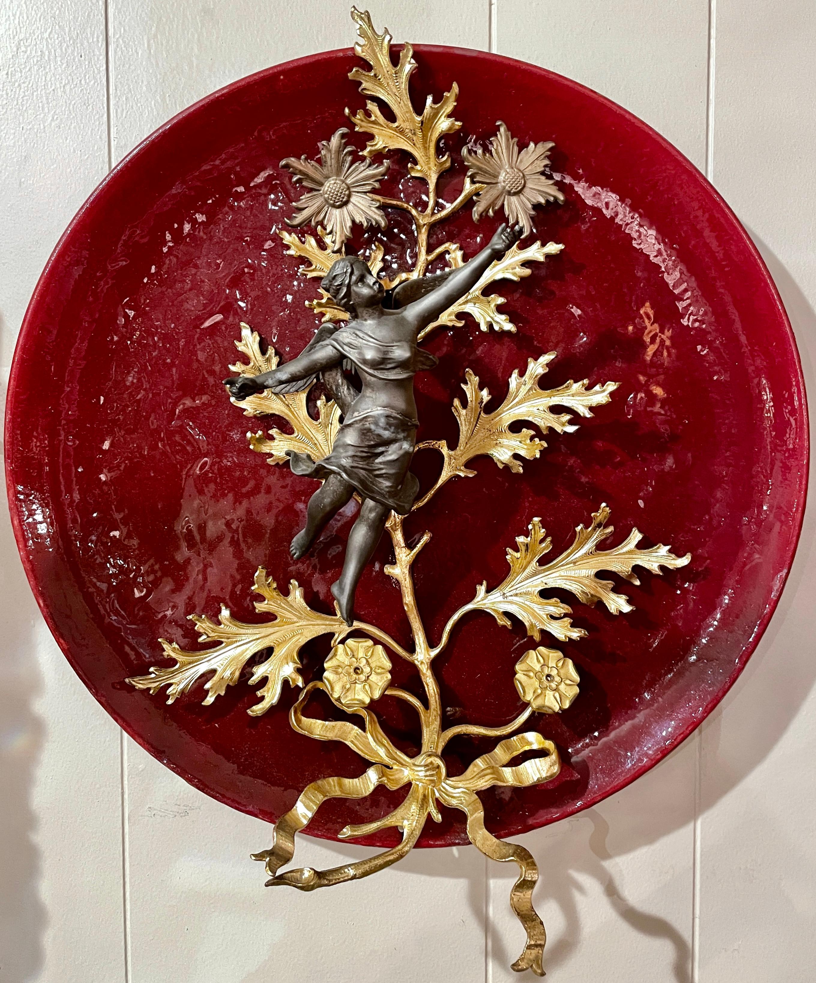 Pair antique French Faience red porcelain, patinated bronze & gold ormolu plates, circa 1890's. Figural seraphim angels with leaves and florals.