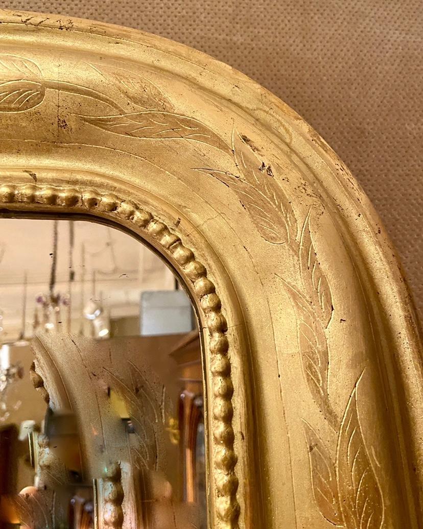 Pair Antique French Louis Philippe Style gold leaf mirrors with Delicate Leaf Details, Circa 1890's.