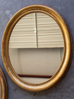 Pair of Antique French Louis Philippe Oval Gold Framed Mirrors, circa 1890